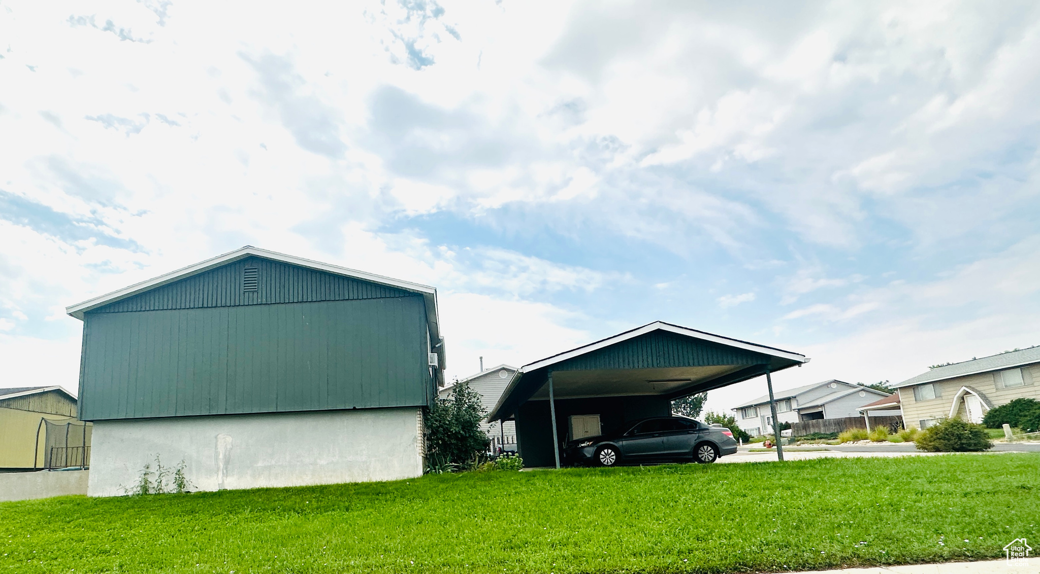 View of property exterior with a yard