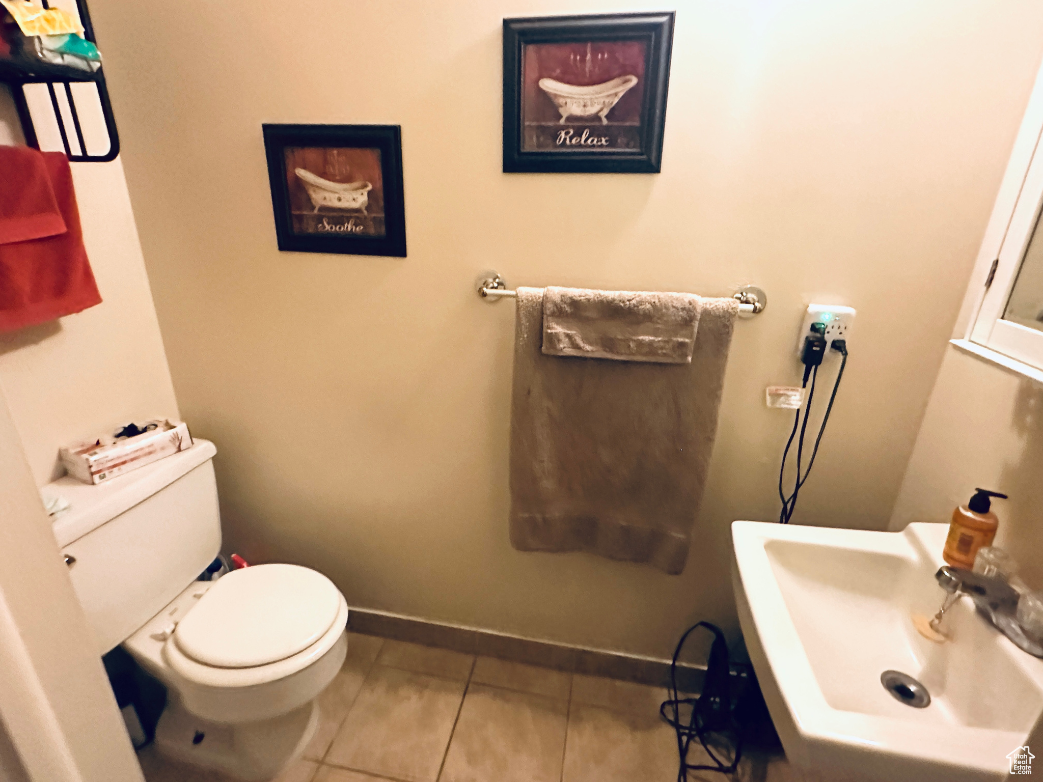 Bathroom featuring toilet, tile patterned flooring, and sink