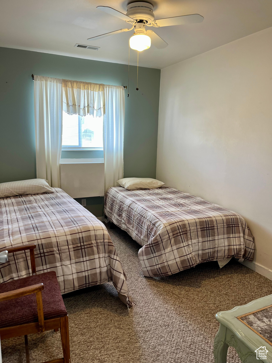 Carpeted bedroom with ceiling fan