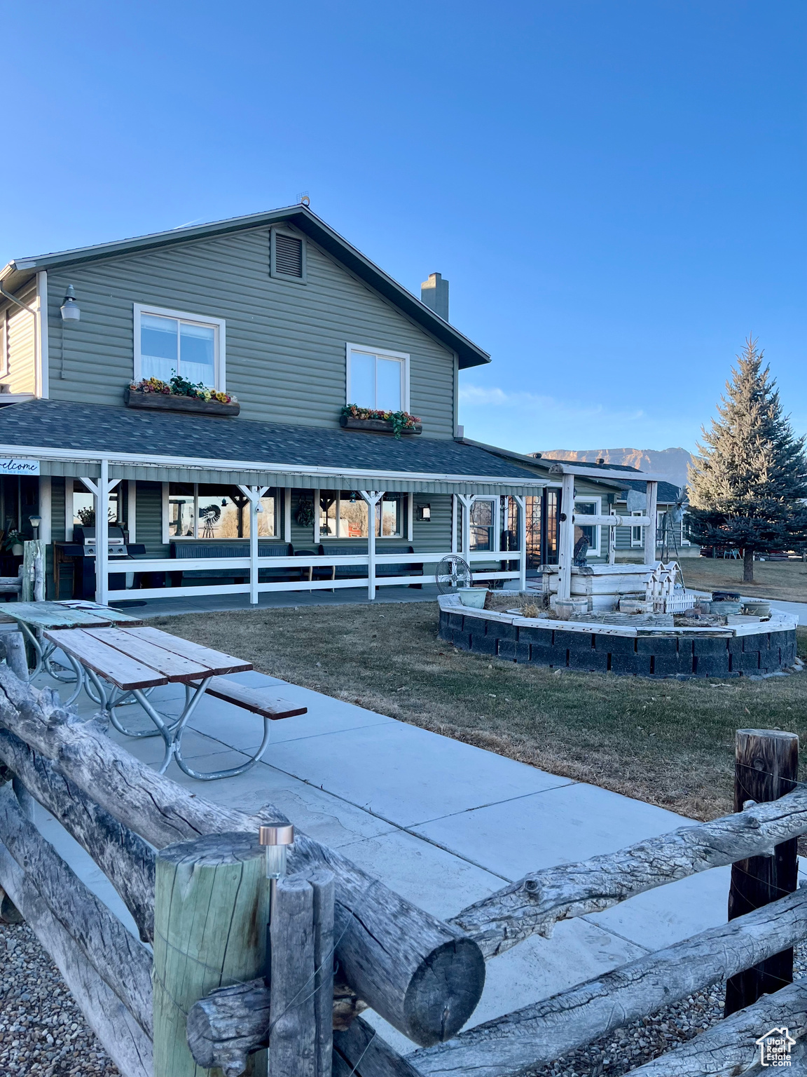 Back of house with a porch and a lawn