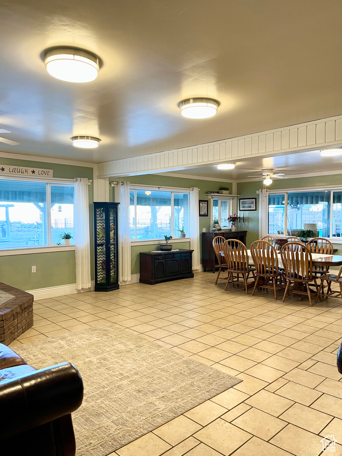 Interior space featuring light tile patterned flooring and ceiling fan