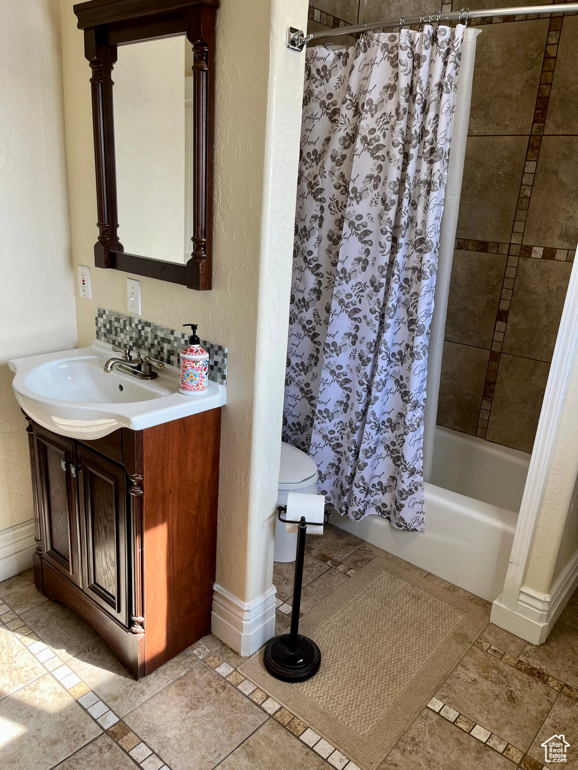 Bathroom featuring vanity and shower / tub combo