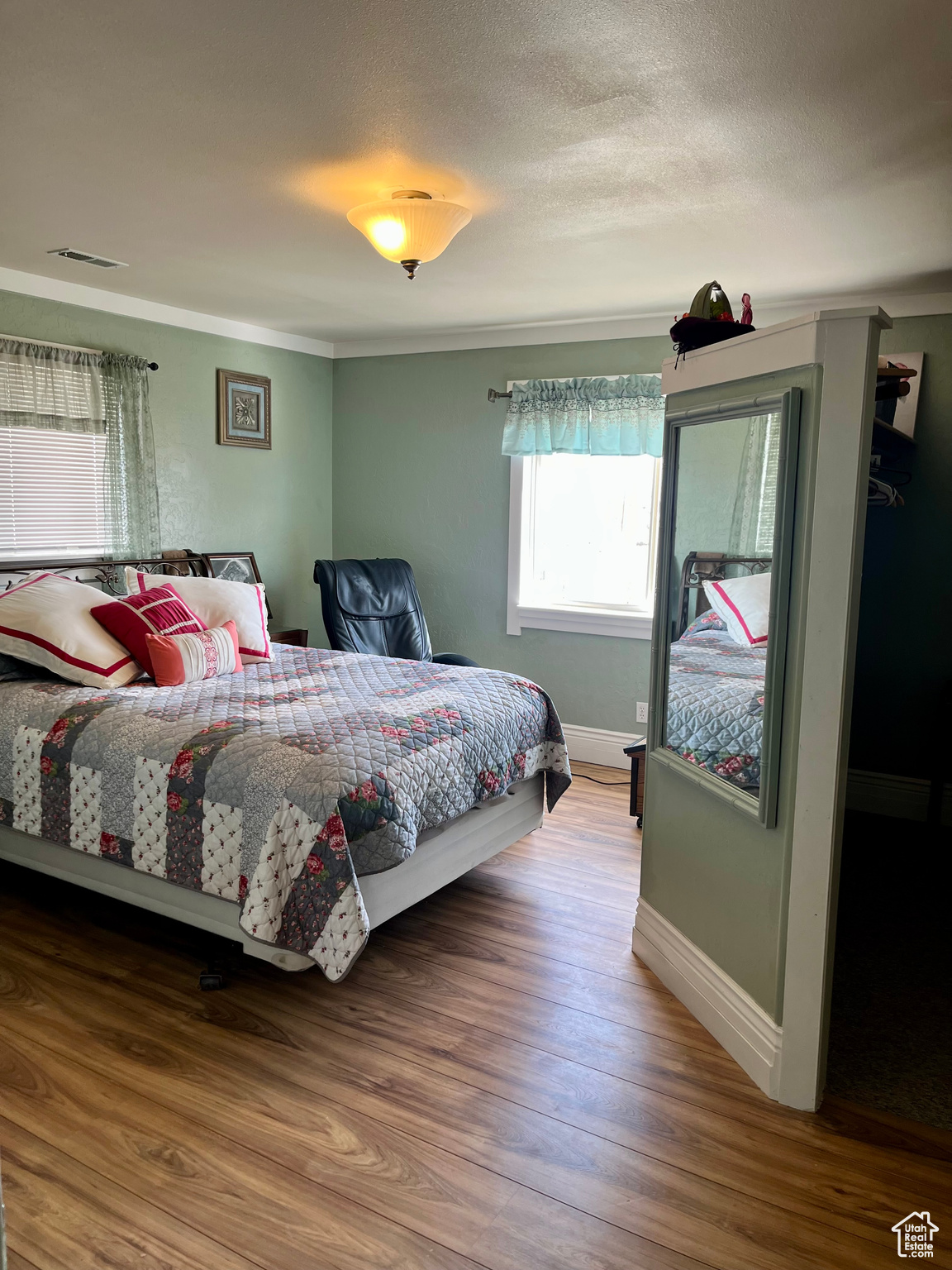 Bedroom featuring hardwood / wood-style floors and a textured ceiling