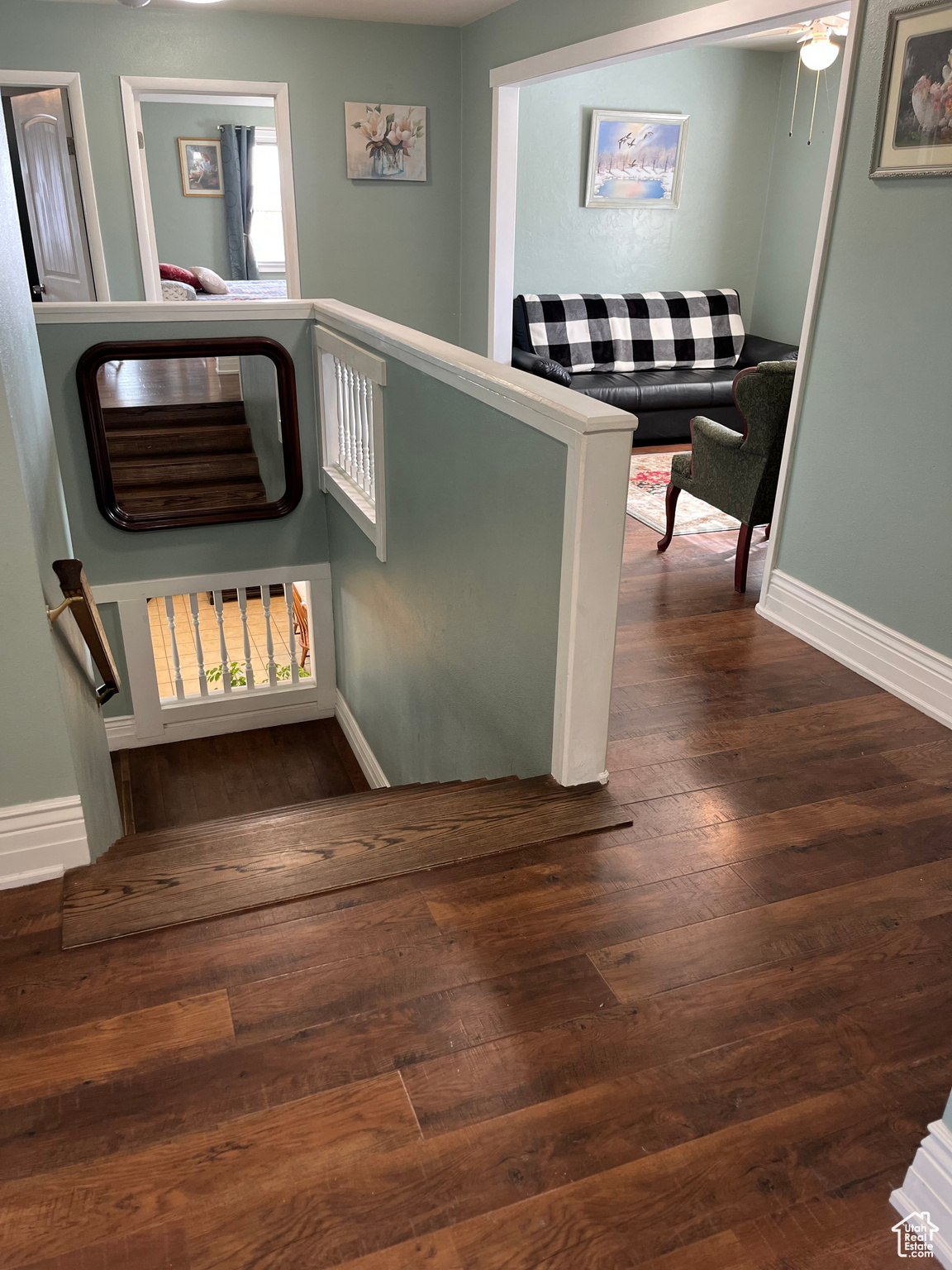 Hallway with dark hardwood / wood-style floors
