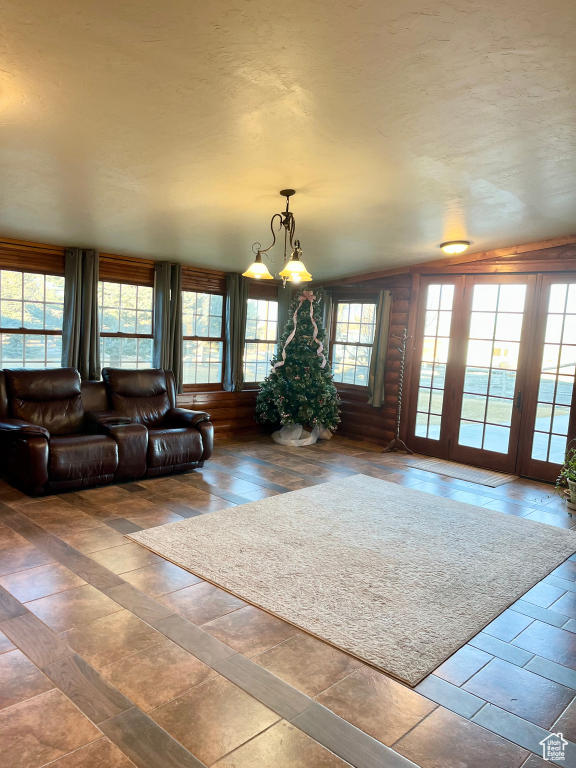 Large Living room with a view of the landscaping surrounding the home and 8+ acres of irrigated fields.
