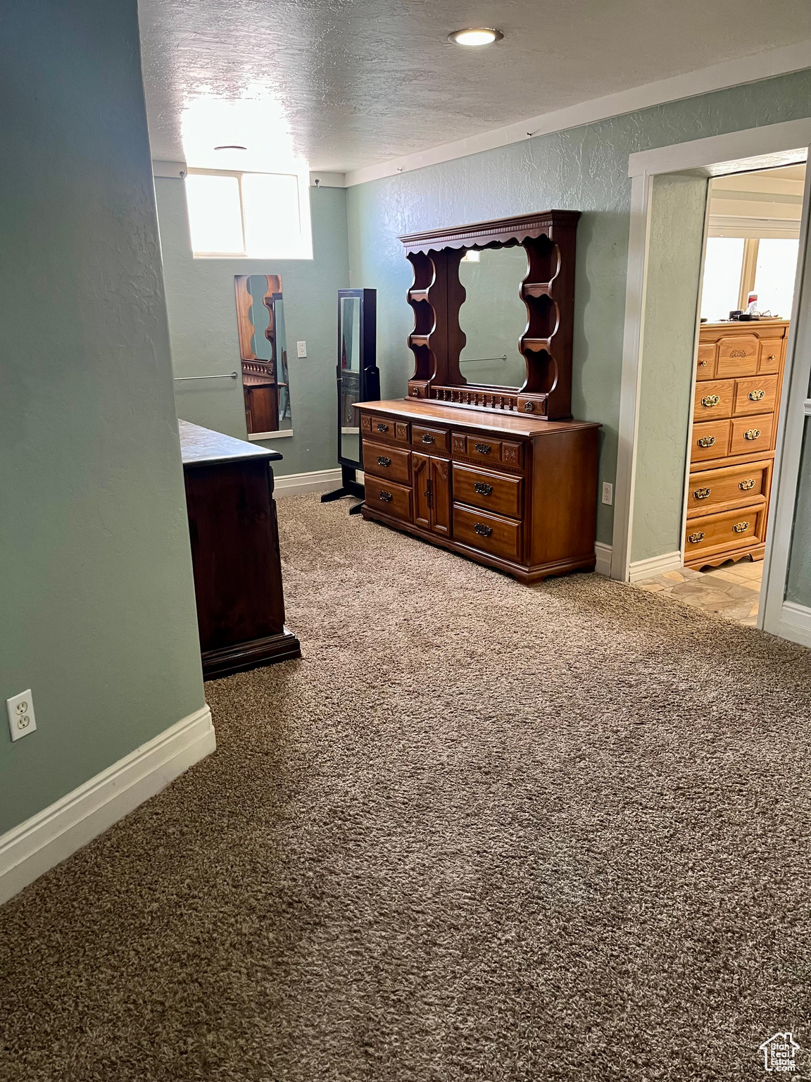 Carpeted bedroom with a textured ceiling