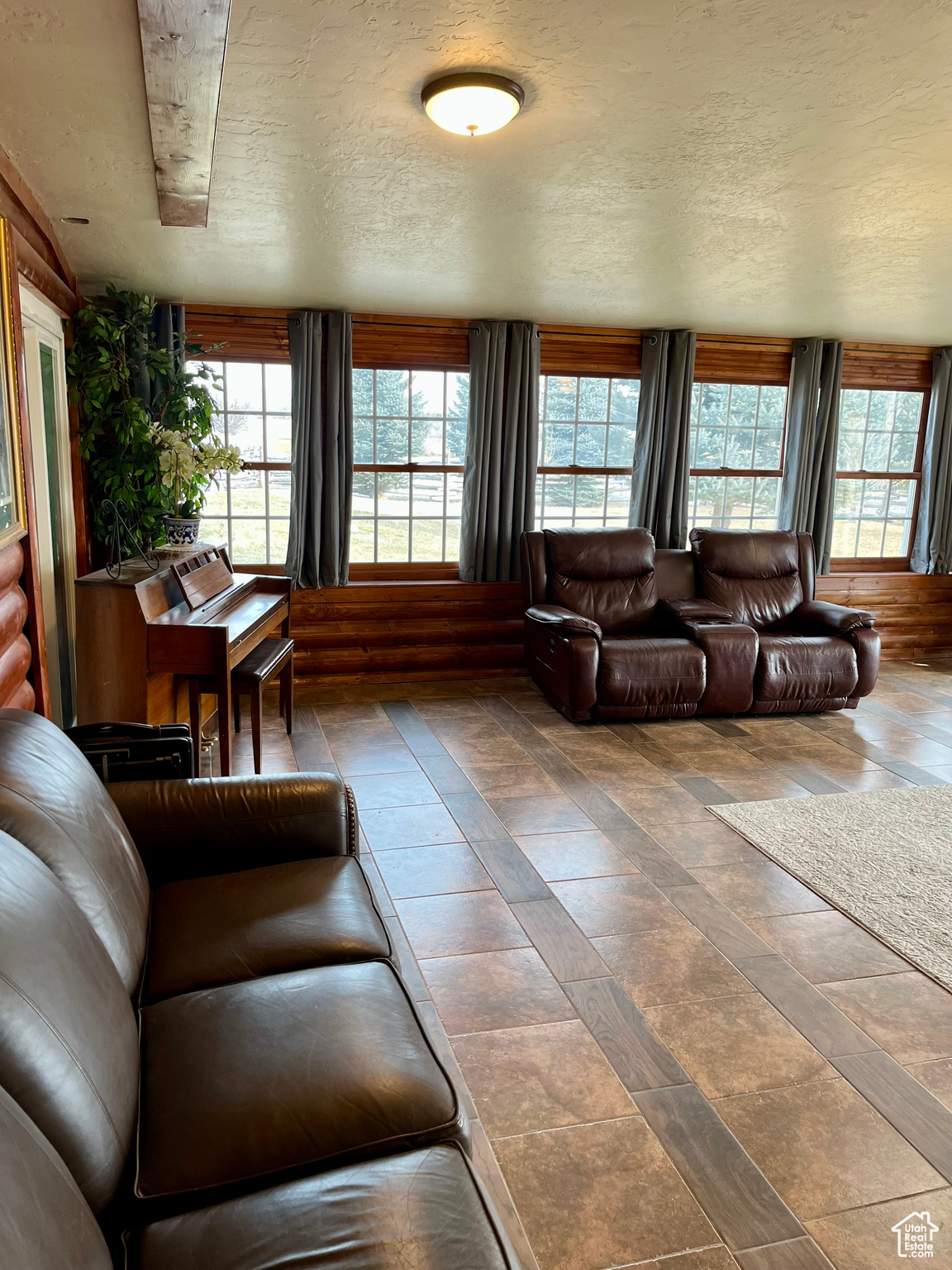 Living room with plenty of natural light and a textured ceiling