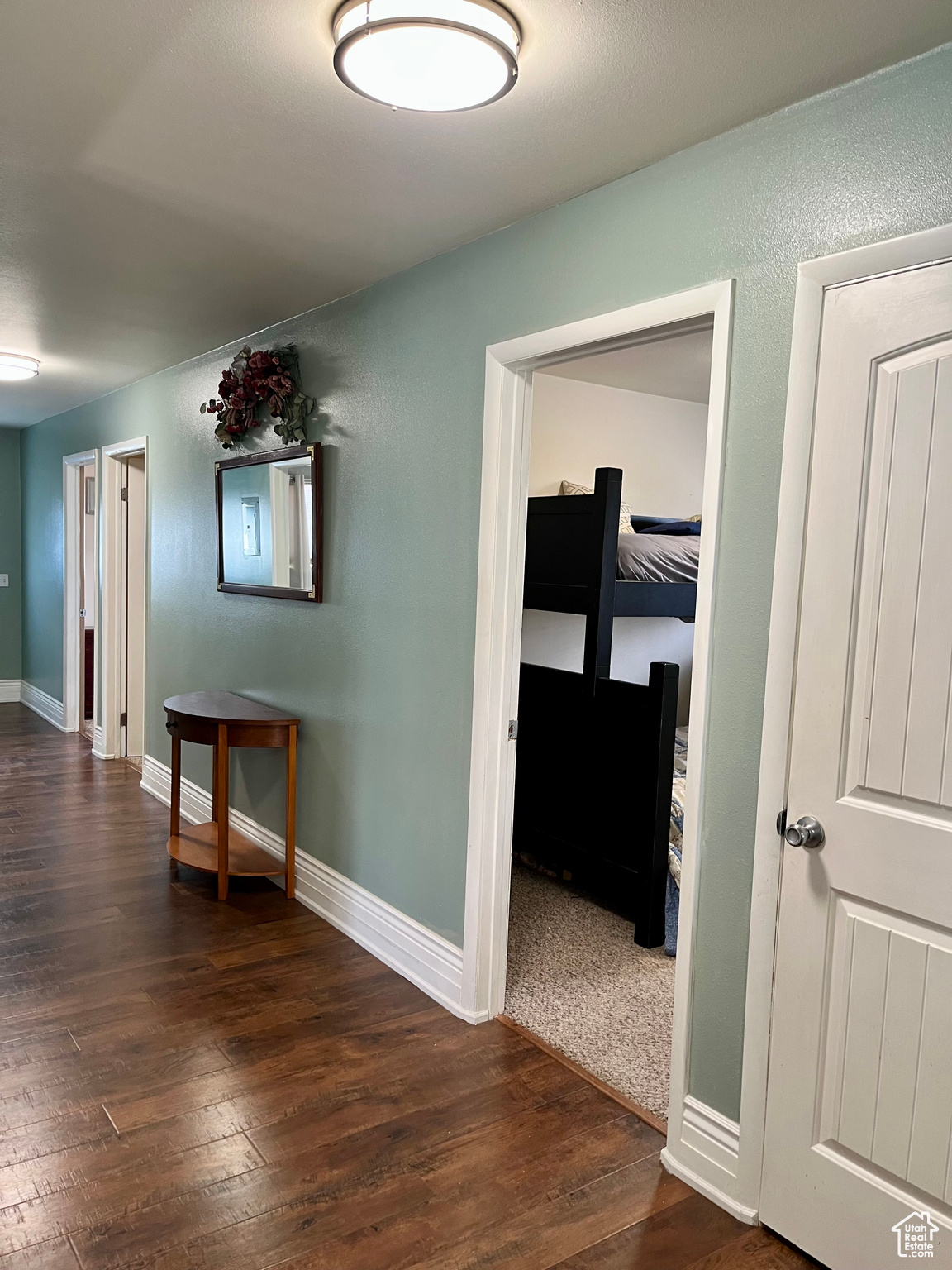 Corridor with dark hardwood / wood-style floors