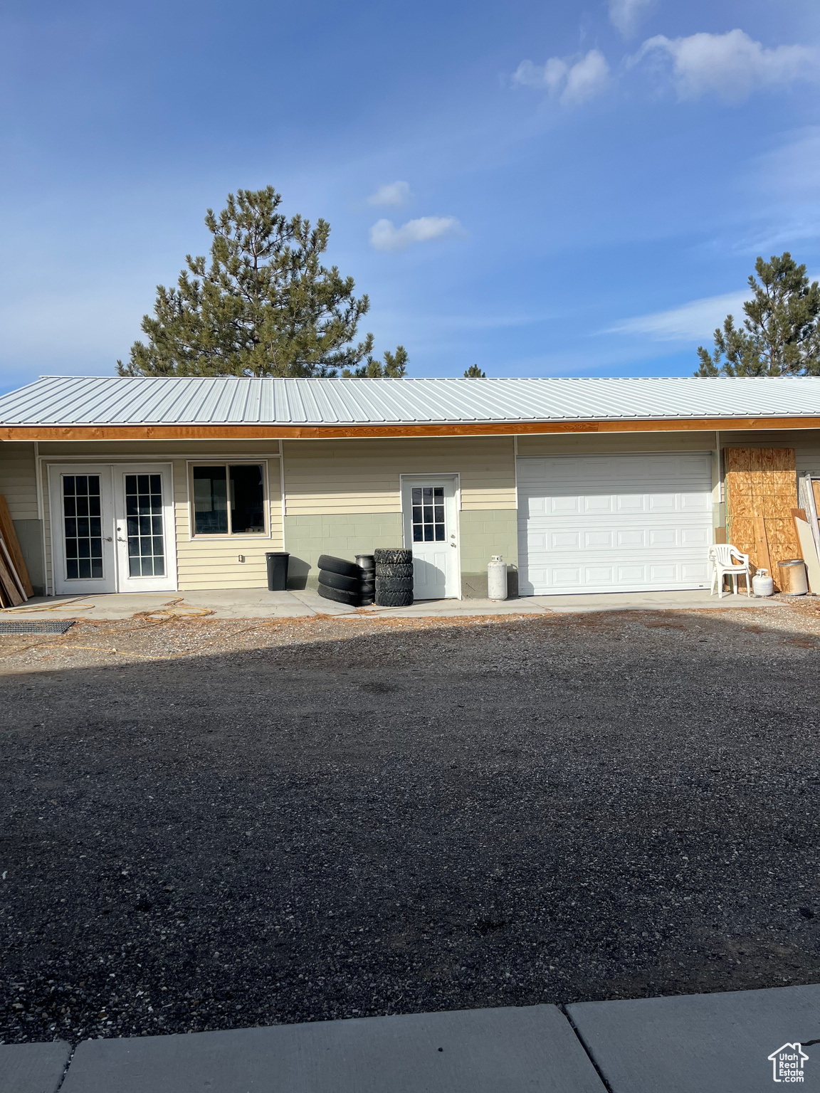 View of front of property with french doors and a garage
