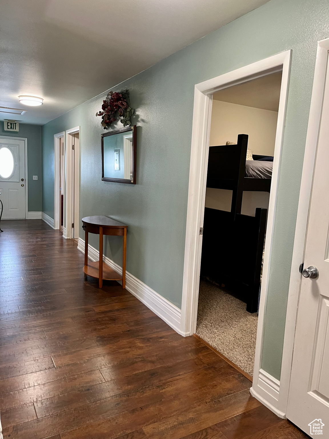 Corridor featuring dark hardwood / wood-style floors