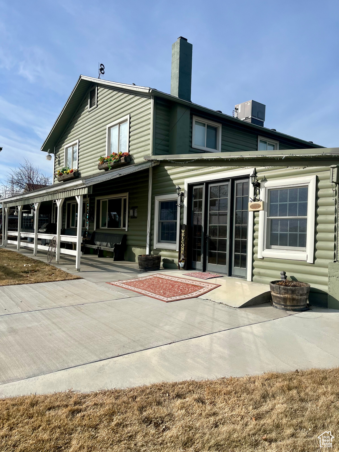 Rear view of house with central AC unit and a patio area