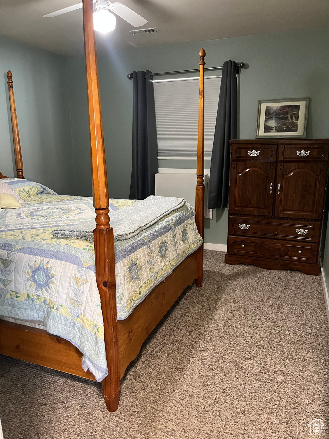 Bedroom featuring ceiling fan and carpet flooring