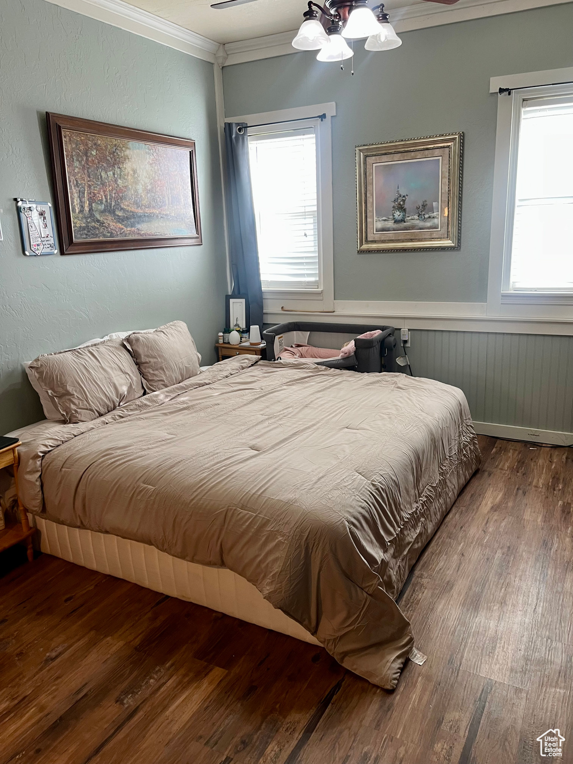 Bedroom with hardwood / wood-style flooring, ornamental molding, and radiator