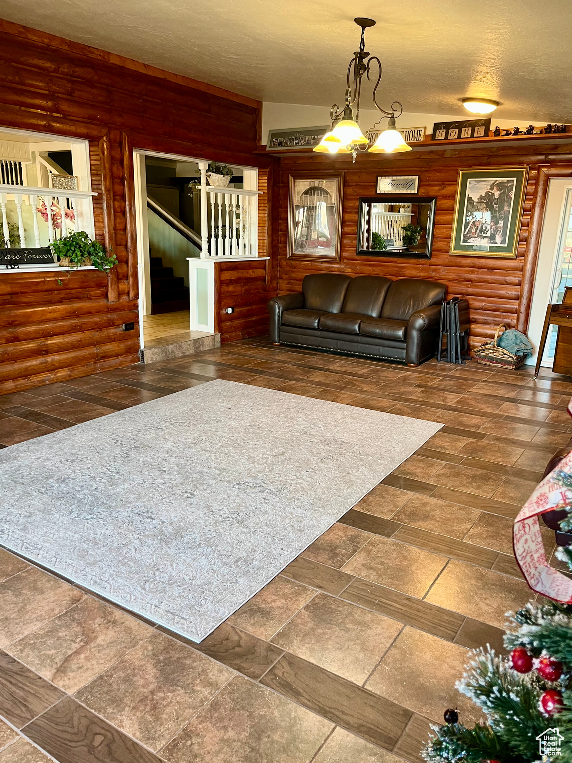 Large Living room with log walls and an inviting cozy wood floors