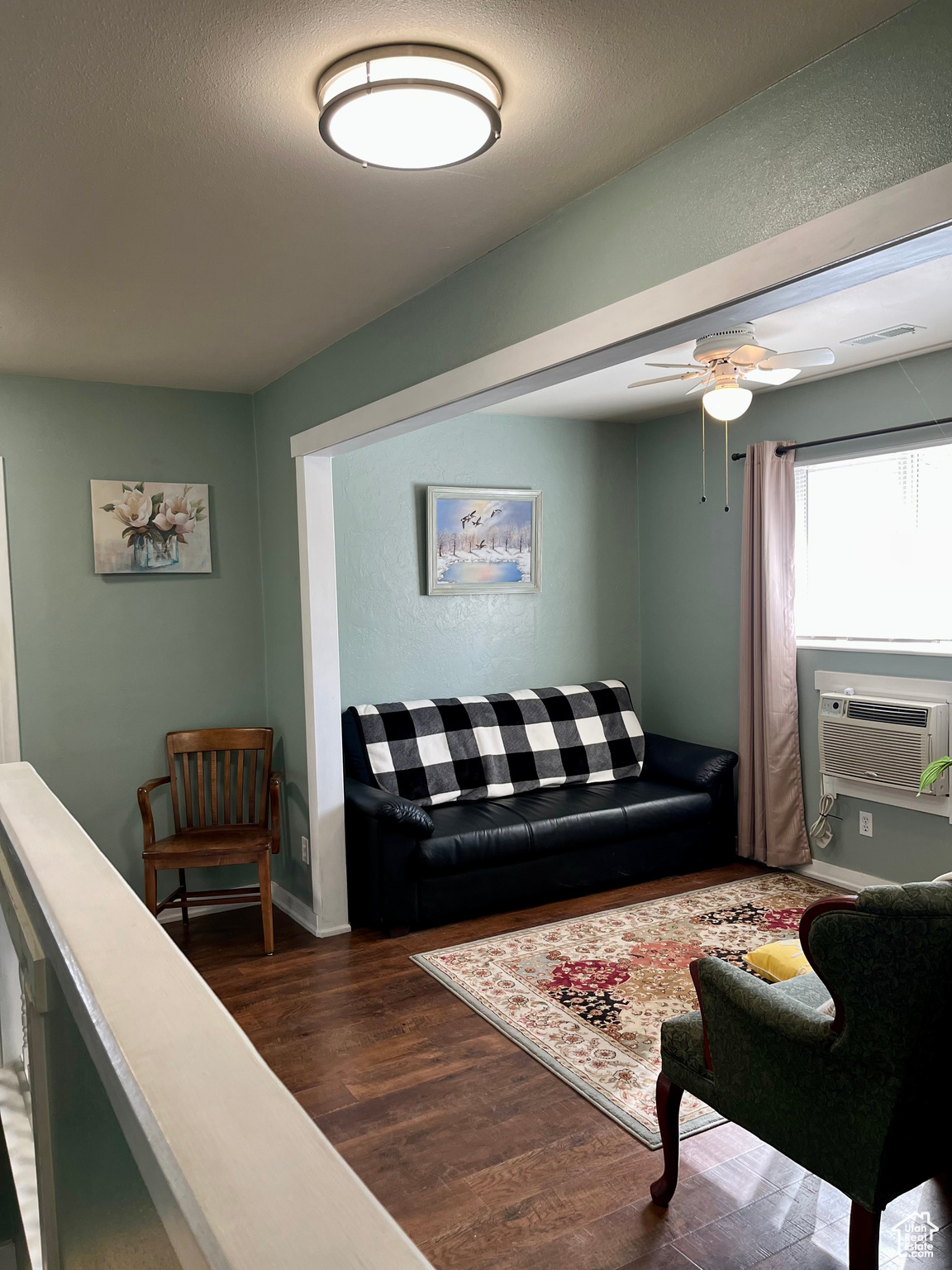 Living room featuring cooling unit, dark hardwood / wood-style floors, and ceiling fan