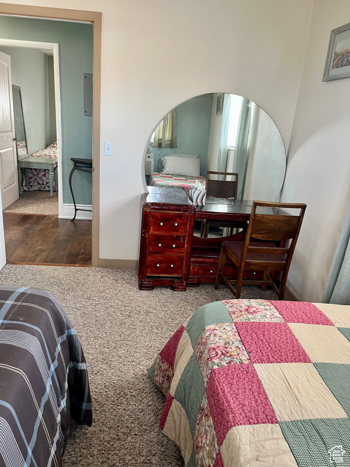 Bedroom featuring carpet flooring and electric panel
