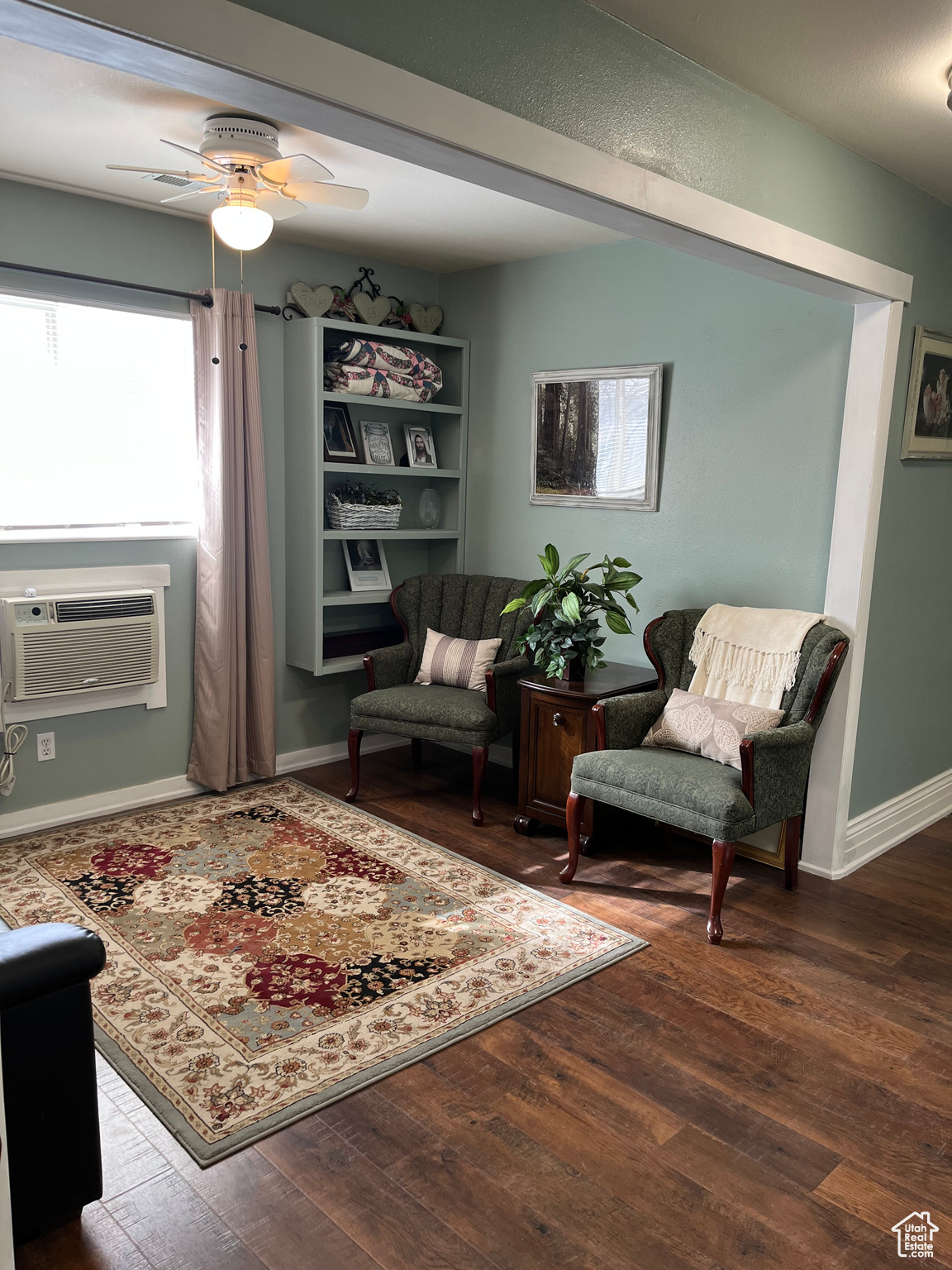 Sitting room with cooling unit, hardwood / wood-style flooring, and ceiling fan