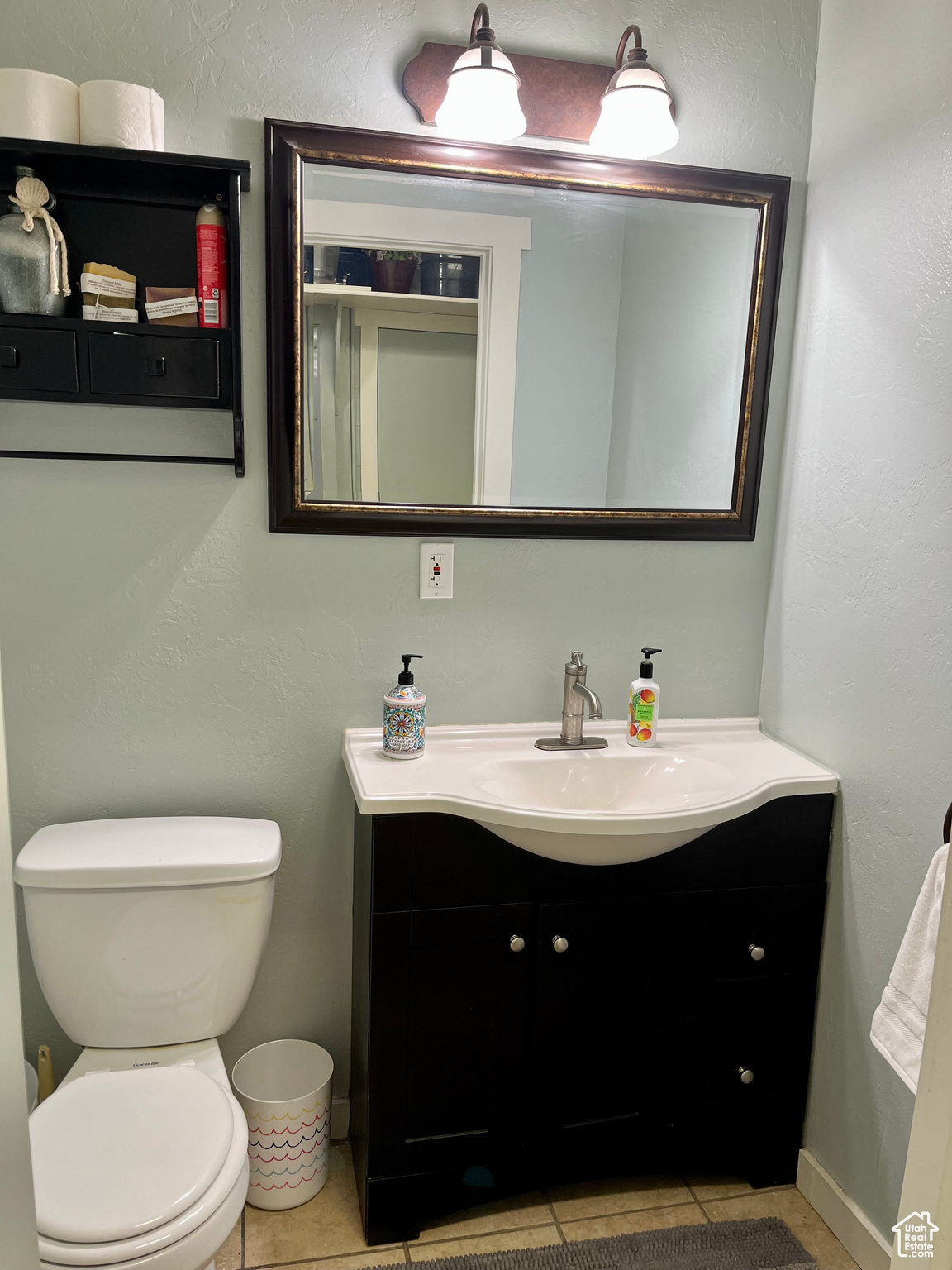 Bathroom featuring vanity, toilet, and tile patterned flooring