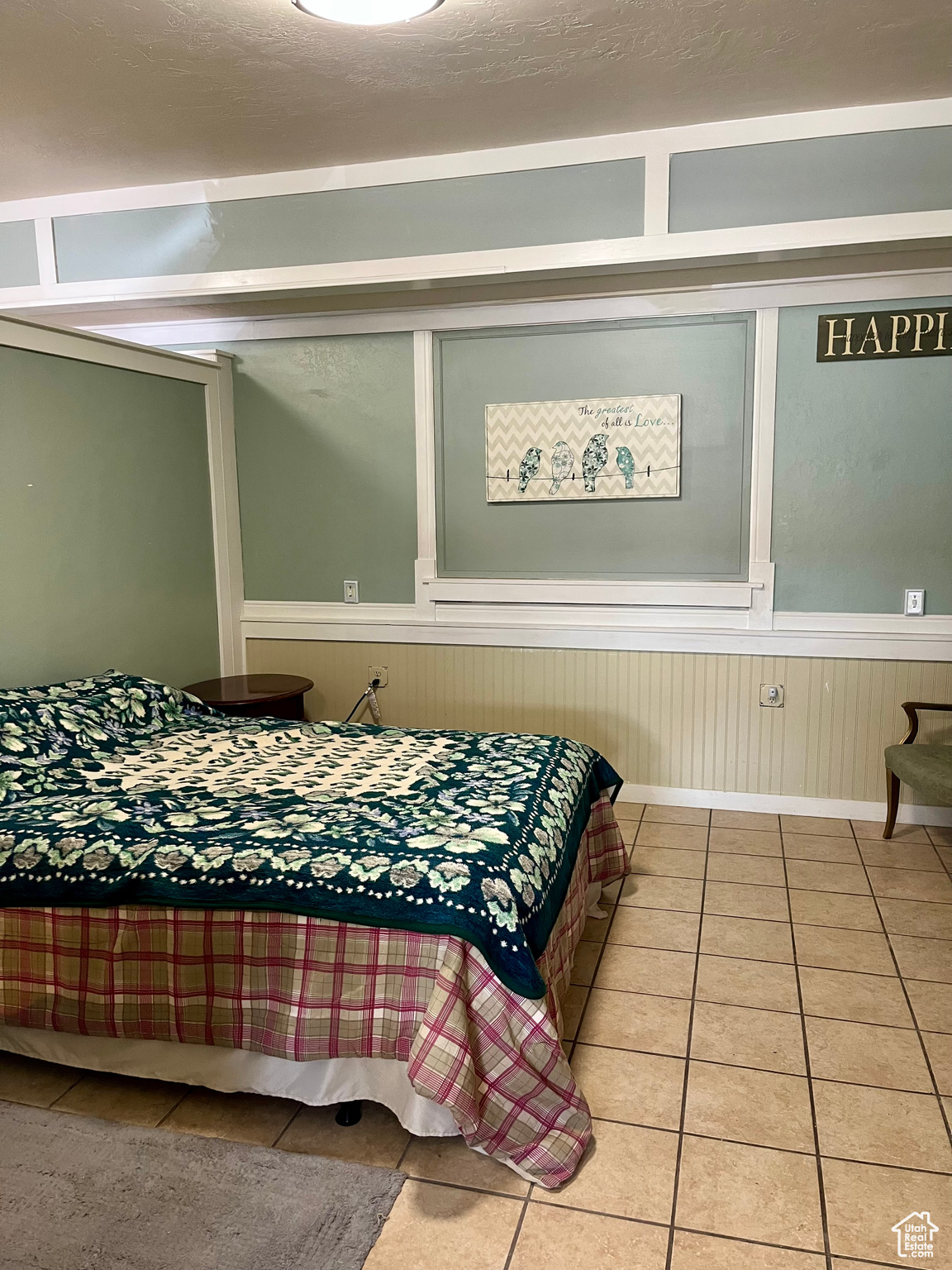 Bedroom featuring tile patterned flooring and a textured ceiling