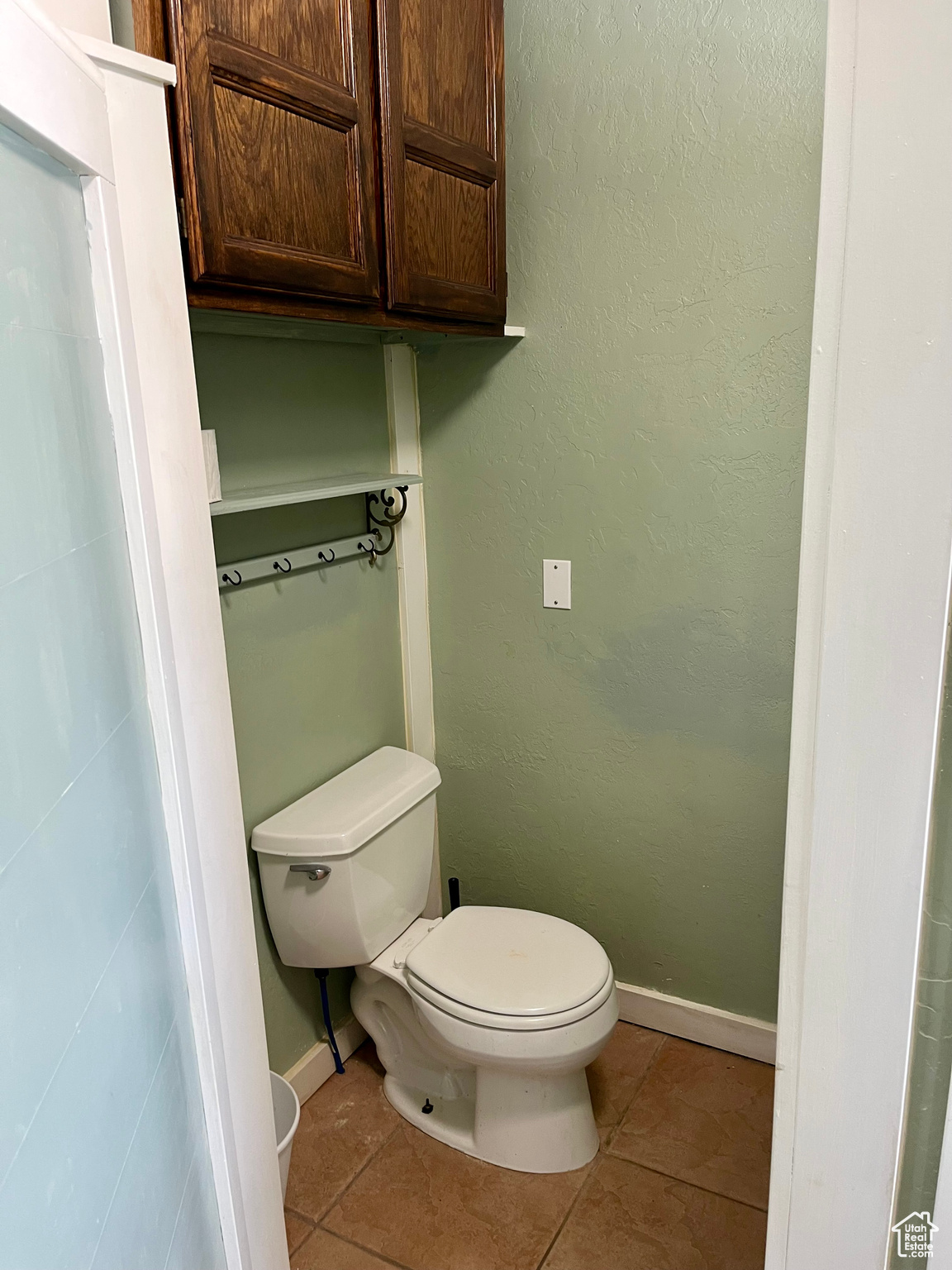 Bathroom with toilet and tile patterned flooring