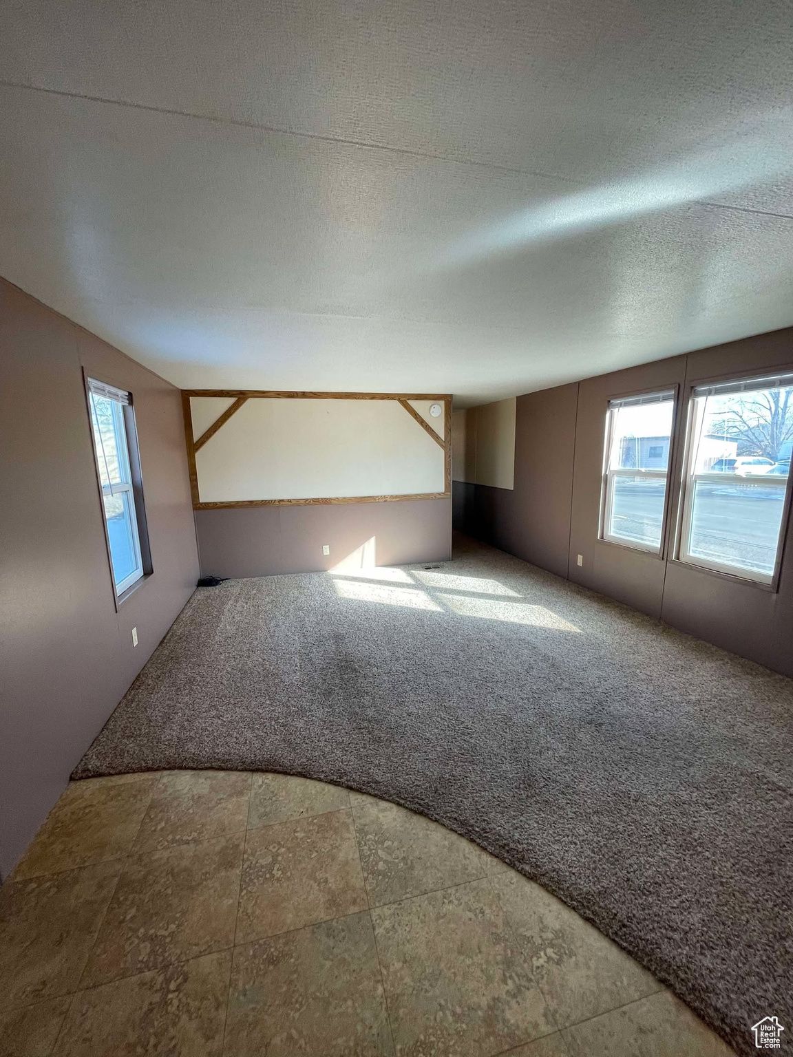 Unfurnished room with carpet flooring and a textured ceiling