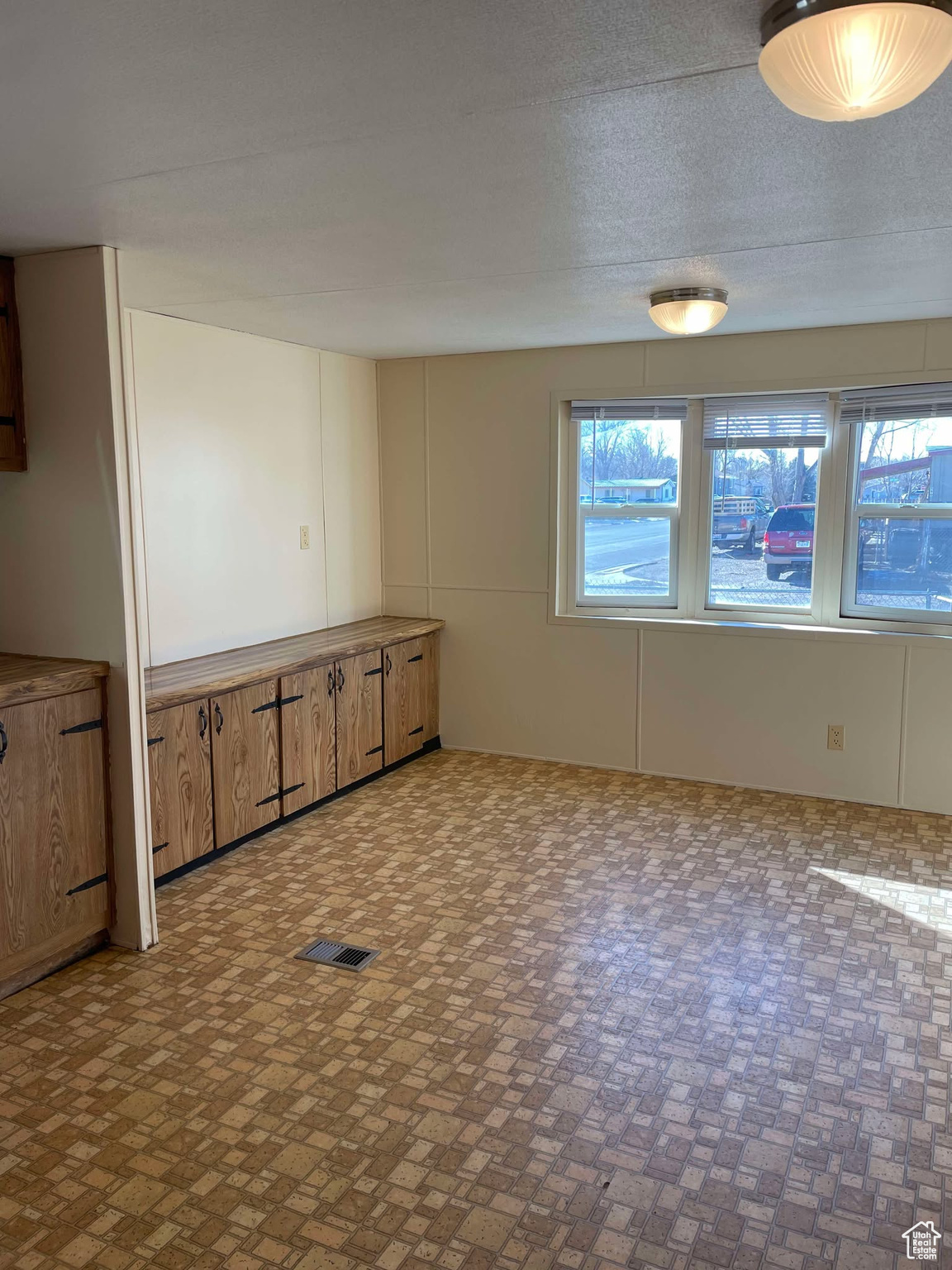 Unfurnished room with a textured ceiling
