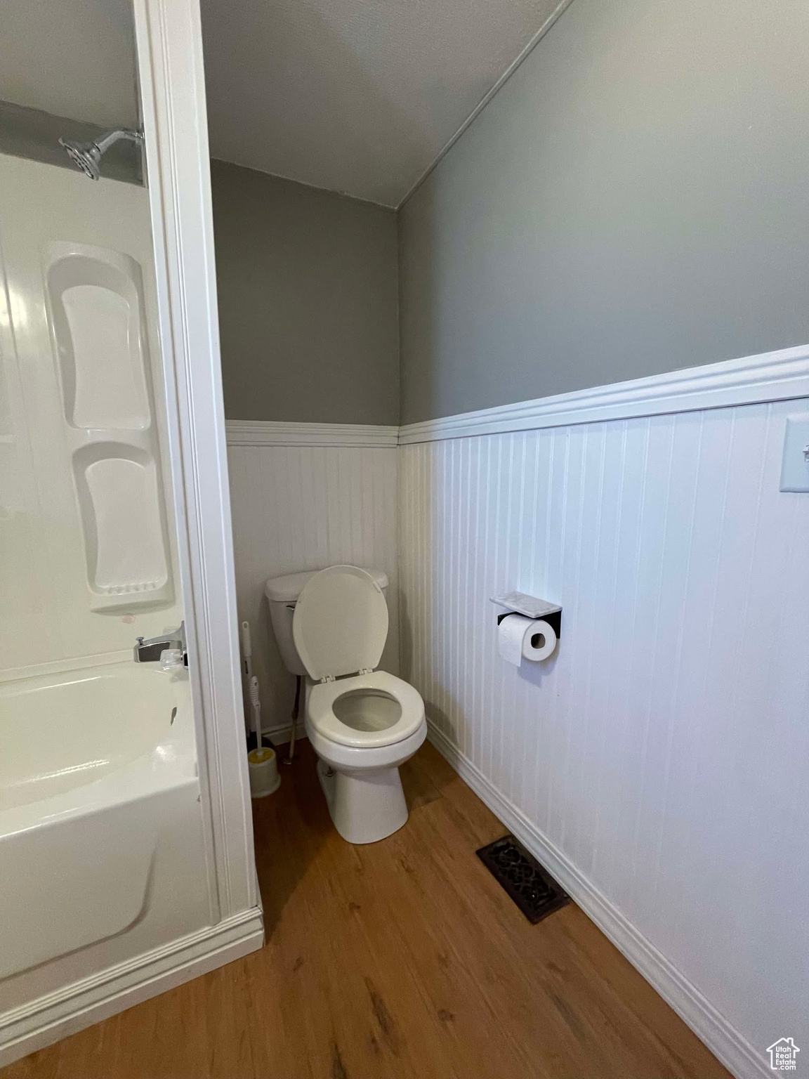 Bathroom featuring wood-type flooring and toilet