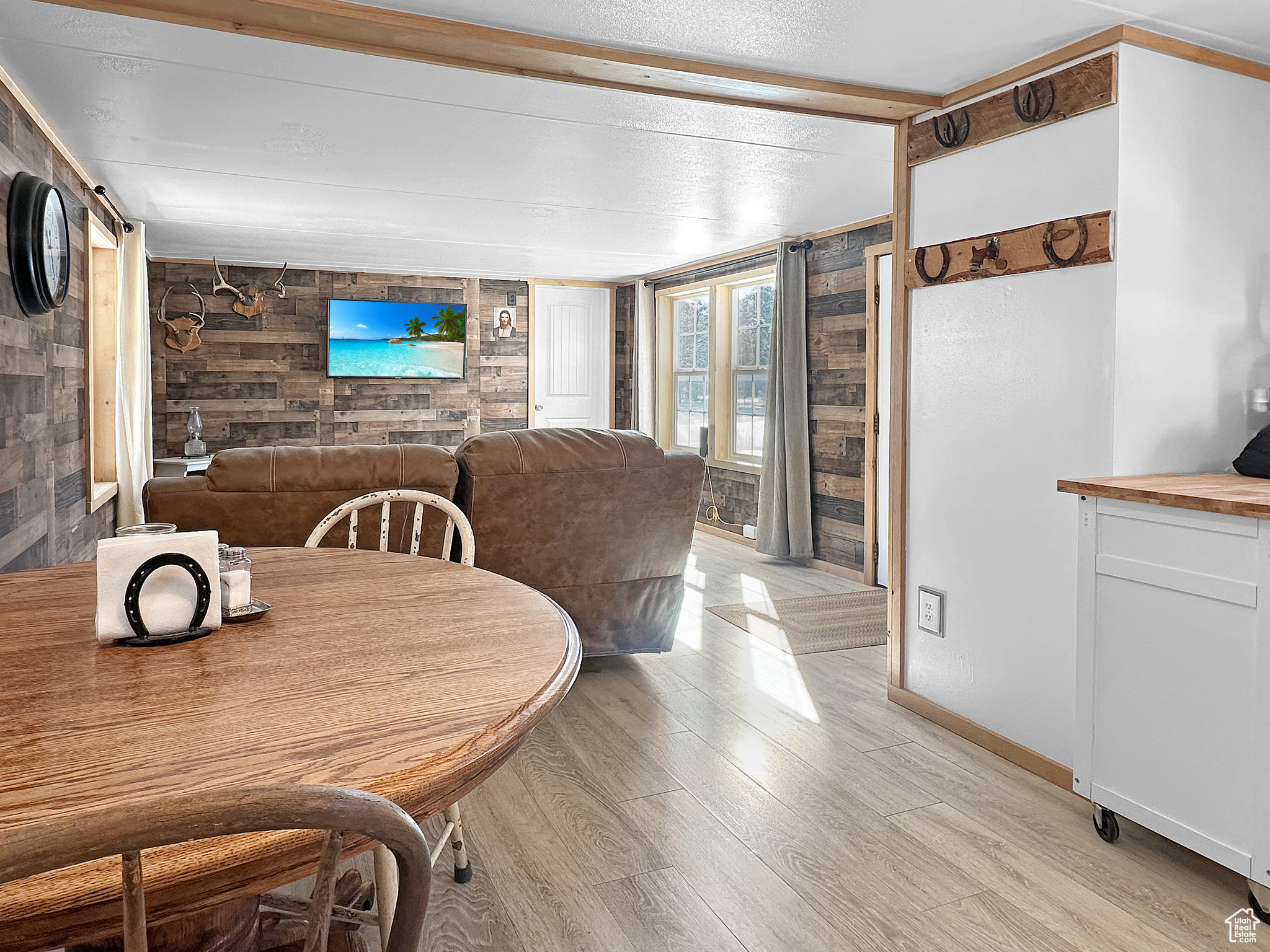 Dining room featuring light hardwood / wood-style flooring and wooden walls