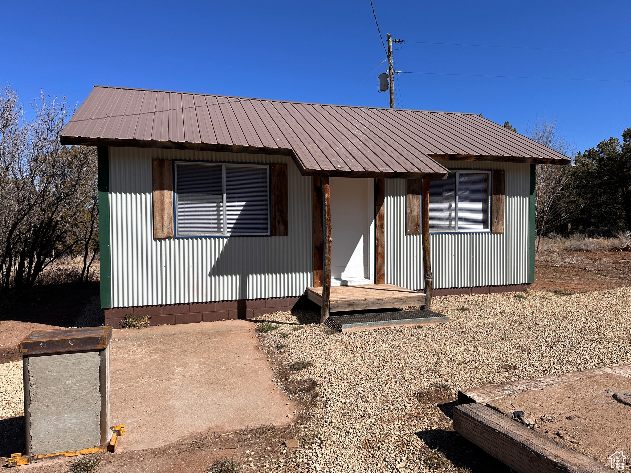 View of front of house with metal roof
