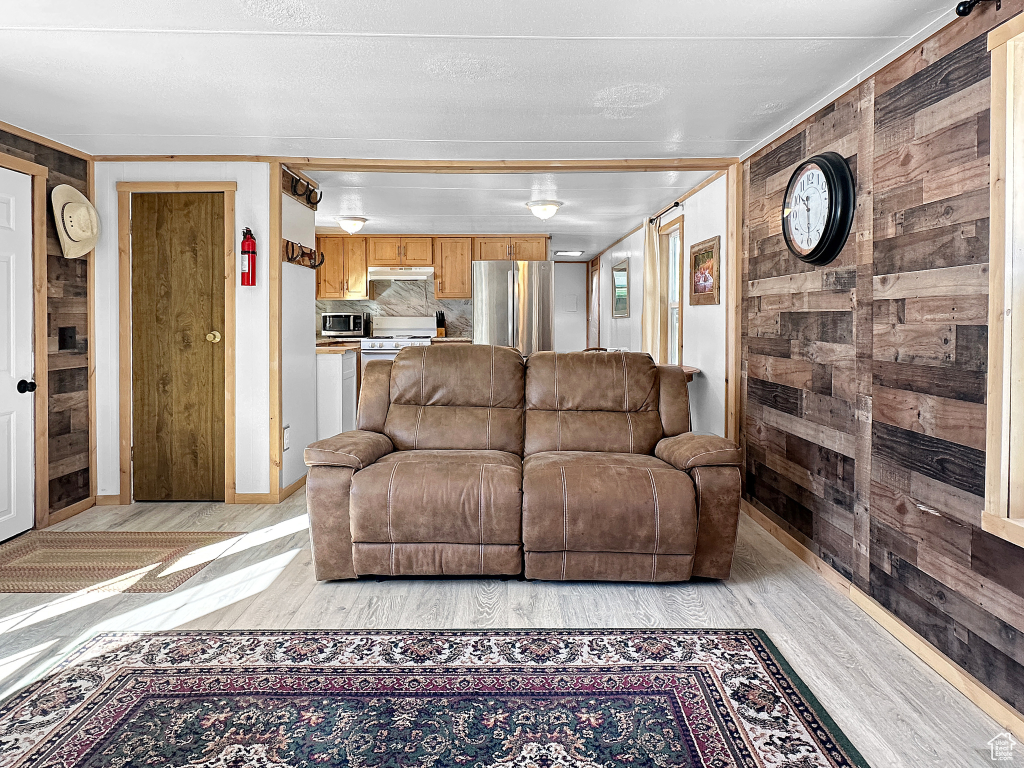 Living room featuring light hardwood / wood-style flooring and wood walls