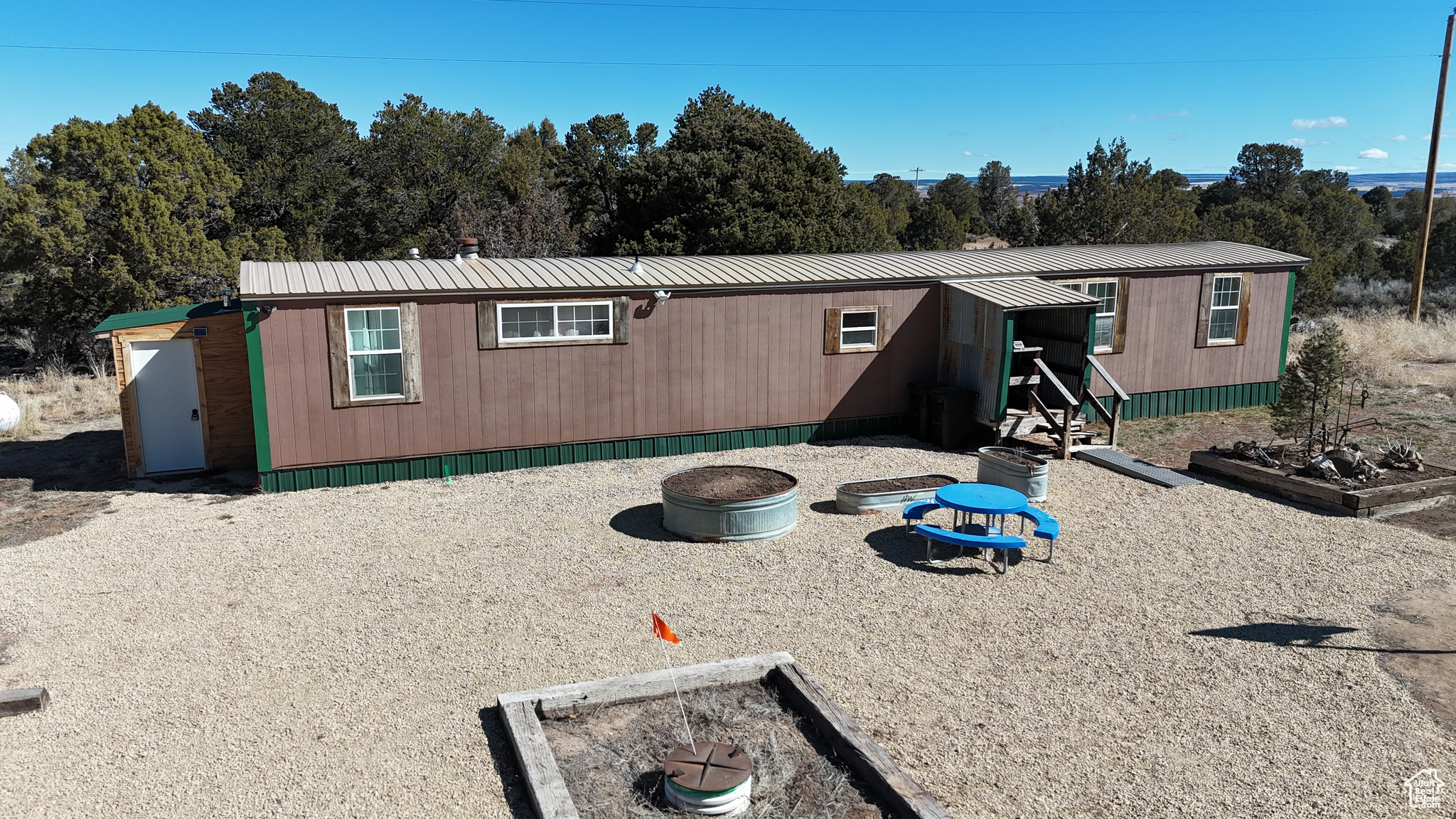 Manufactured / mobile home with a fire pit and metal roof