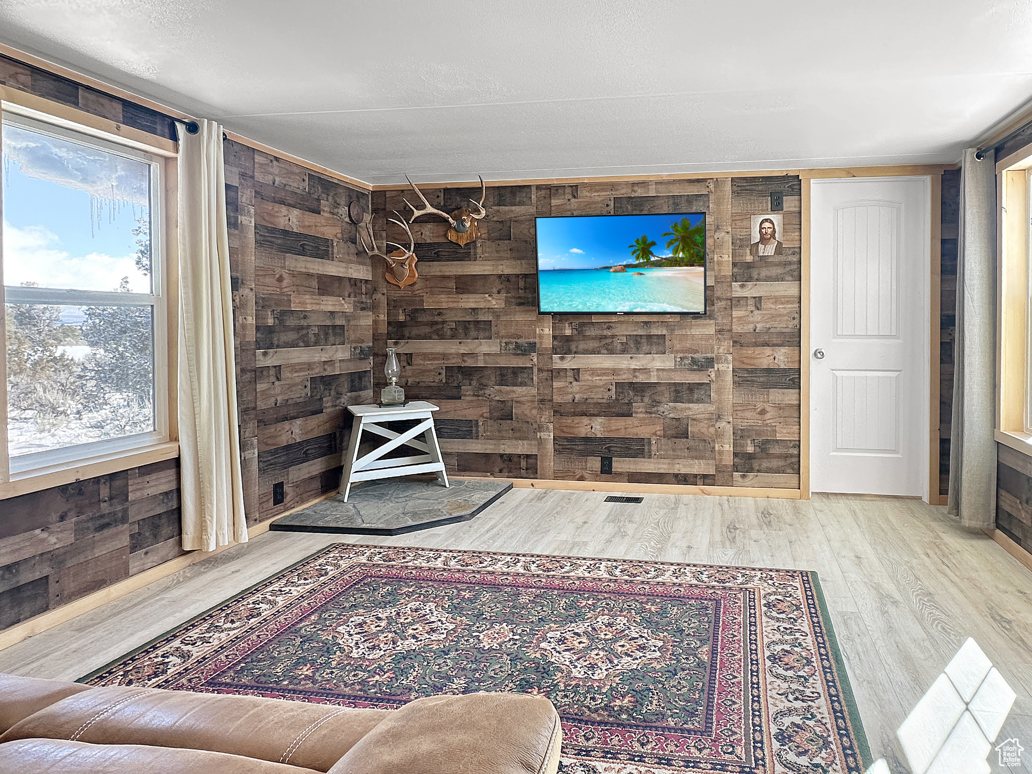 Living room with wood-type flooring and wood walls