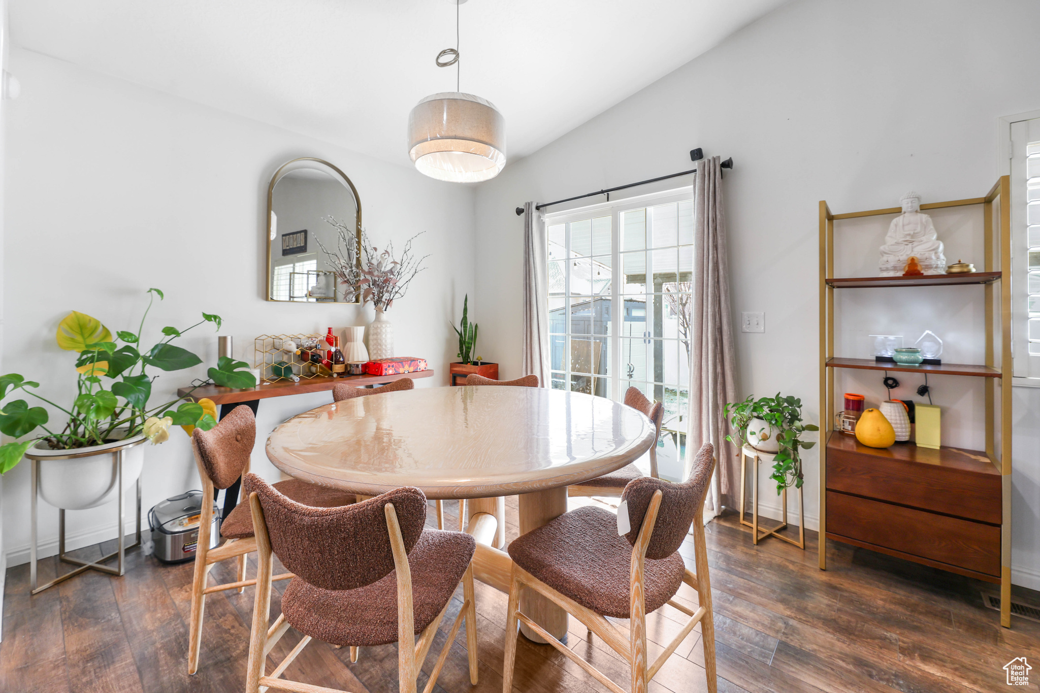 Dining area with lofted ceiling and dark hardwood / wood-style floors