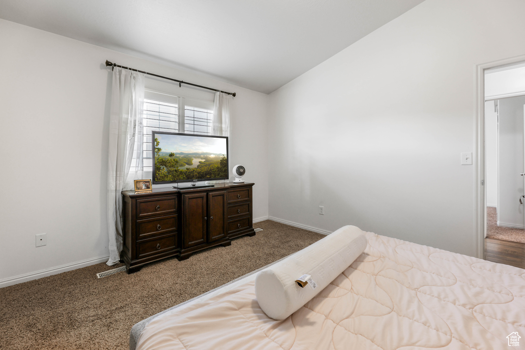 Carpeted bedroom with lofted ceiling