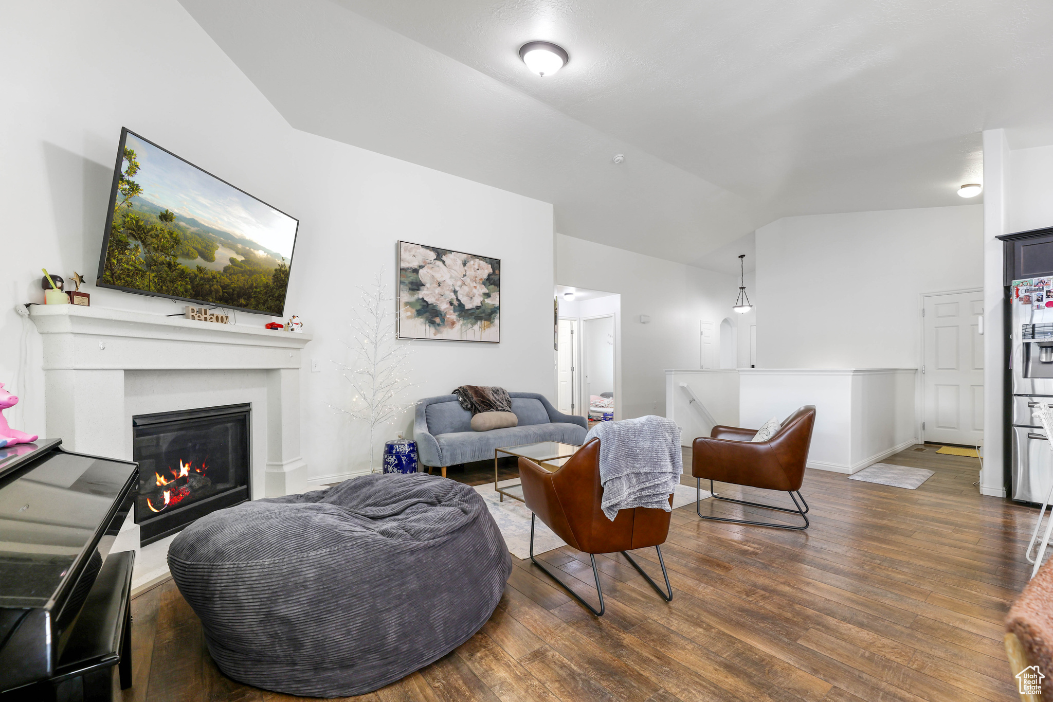 Living room featuring dark hardwood / wood-style flooring and vaulted ceiling