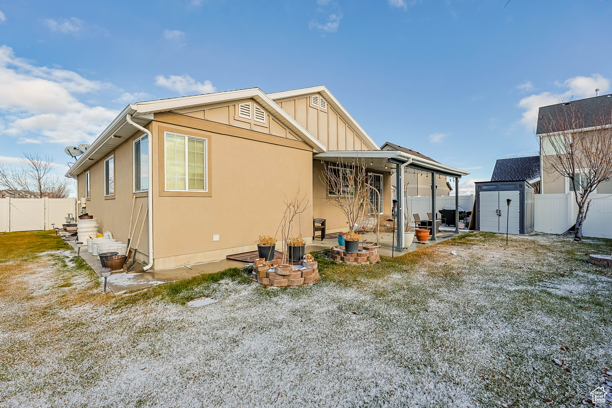 Exterior space with a storage unit, a patio, and an outdoor fire pit