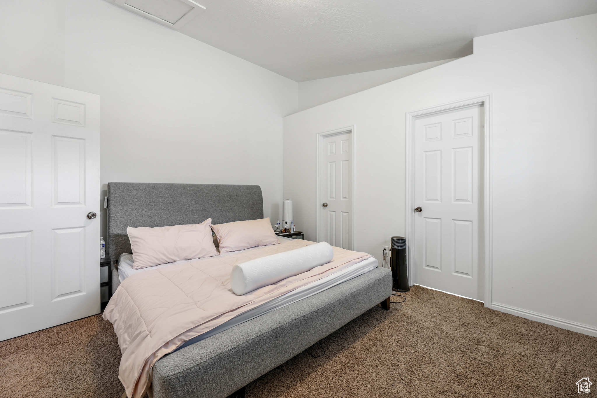 Carpeted bedroom featuring lofted ceiling