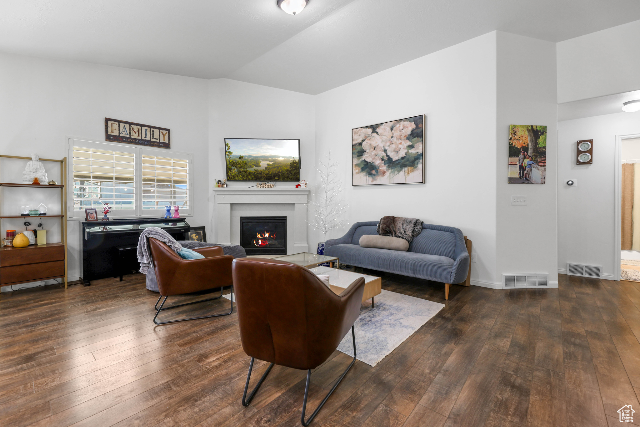 Living room with dark hardwood / wood-style flooring and lofted ceiling