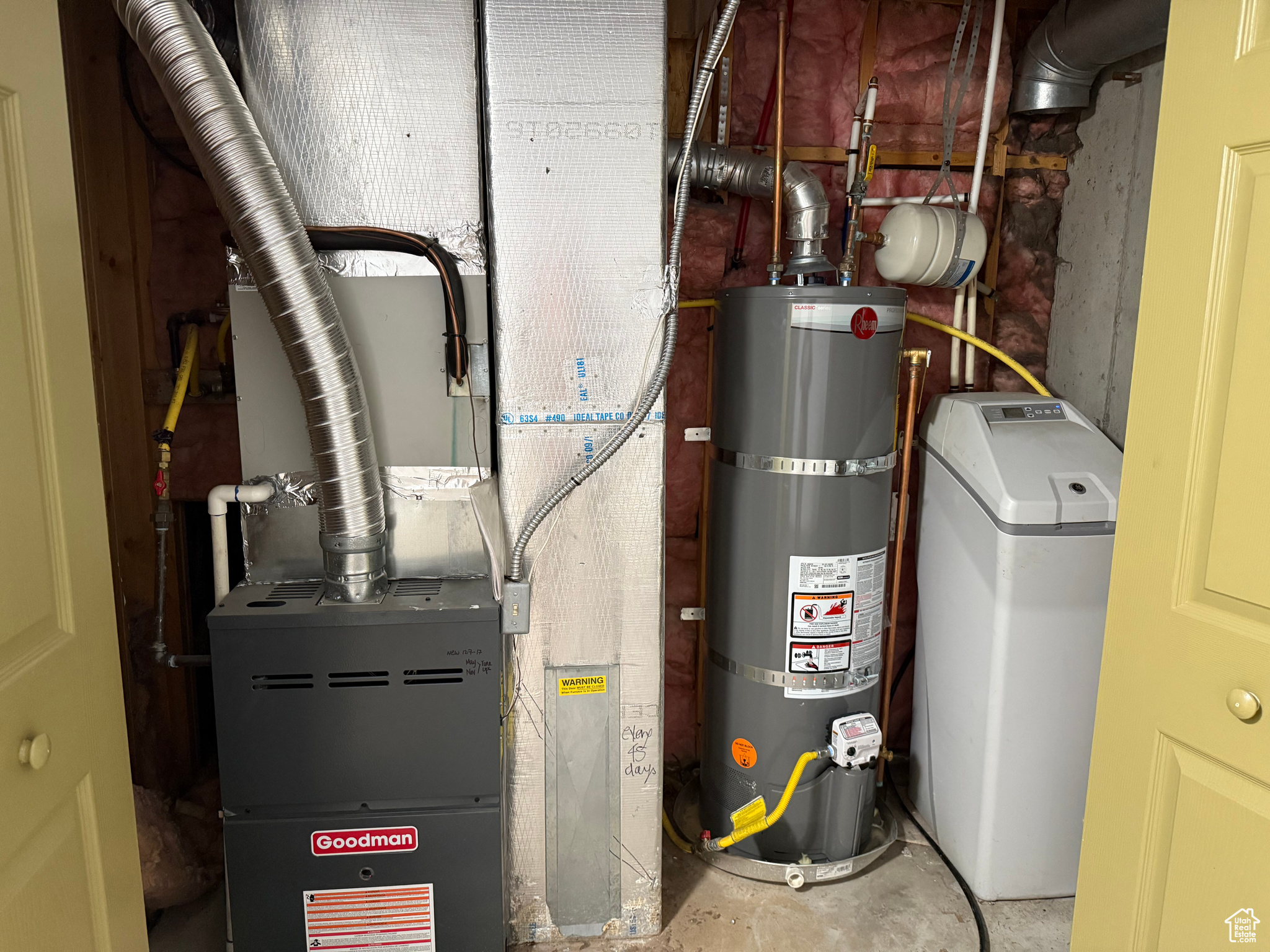 Utility room with water heater and heating unit