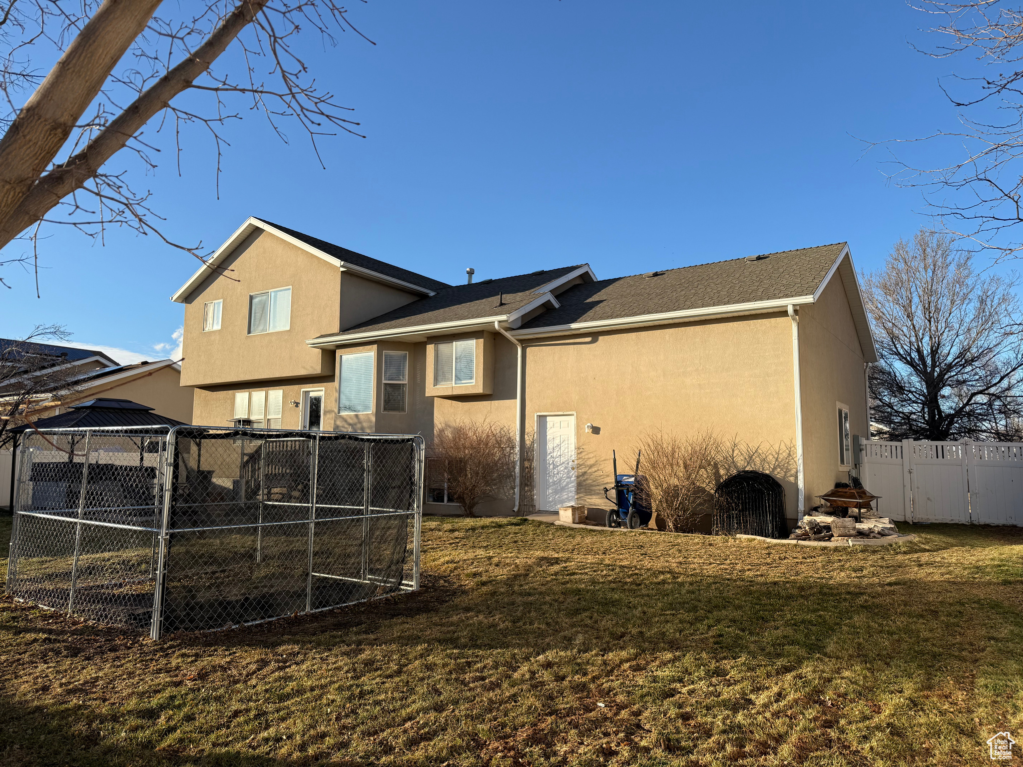 Back of house featuring a yard