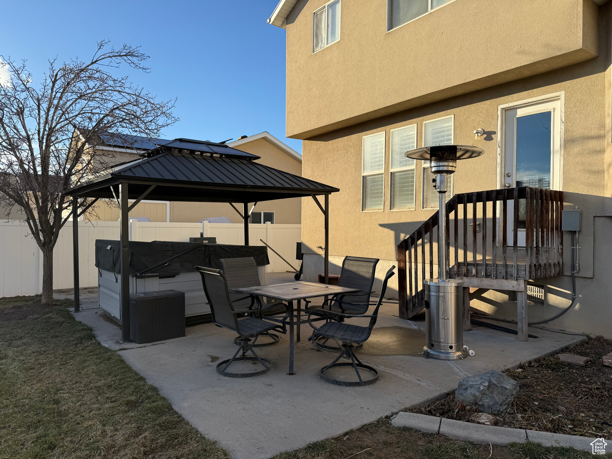 View of patio featuring a gazebo and a hot tub