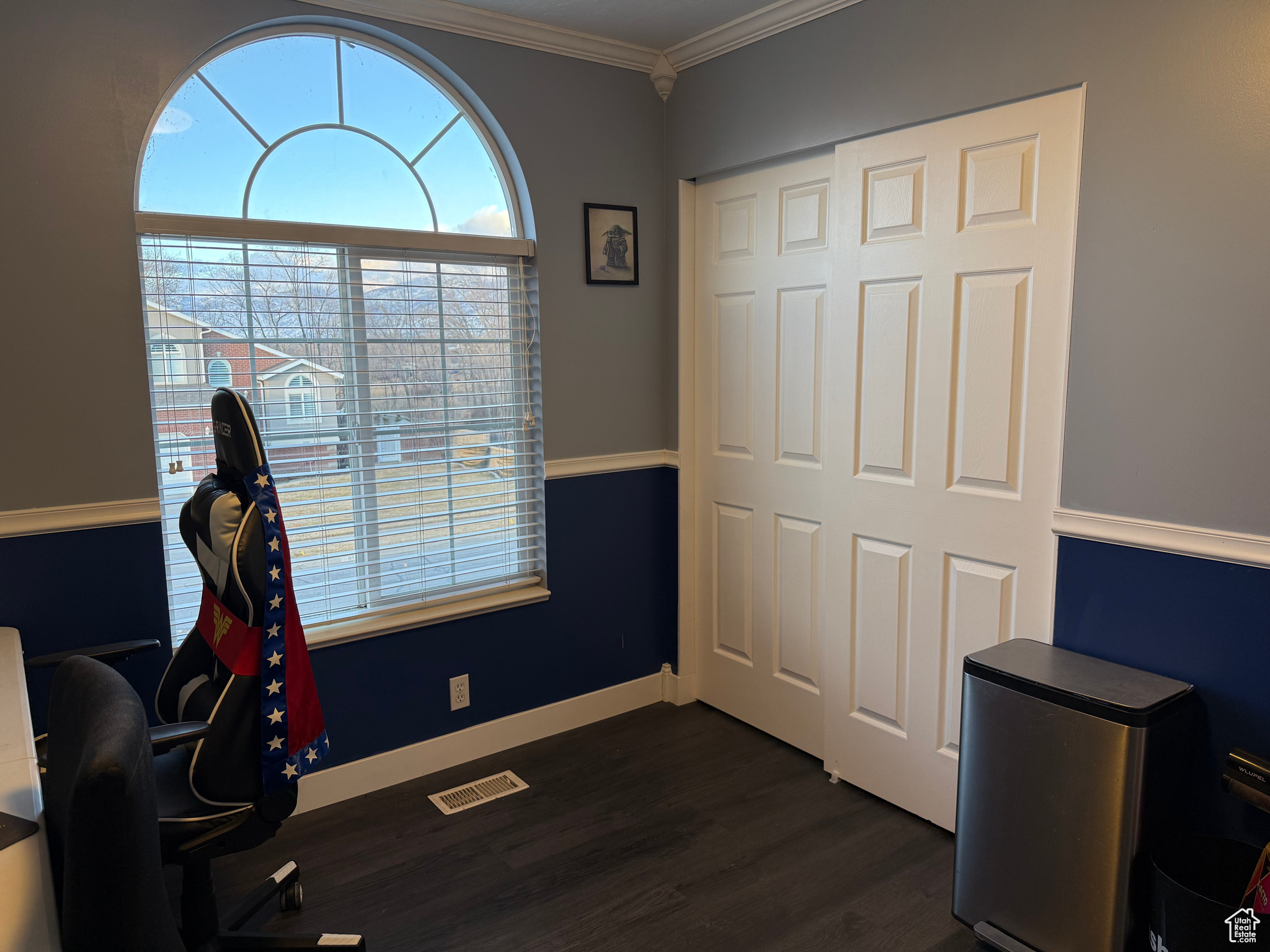 Office space with ornamental molding and dark hardwood / wood-style floors