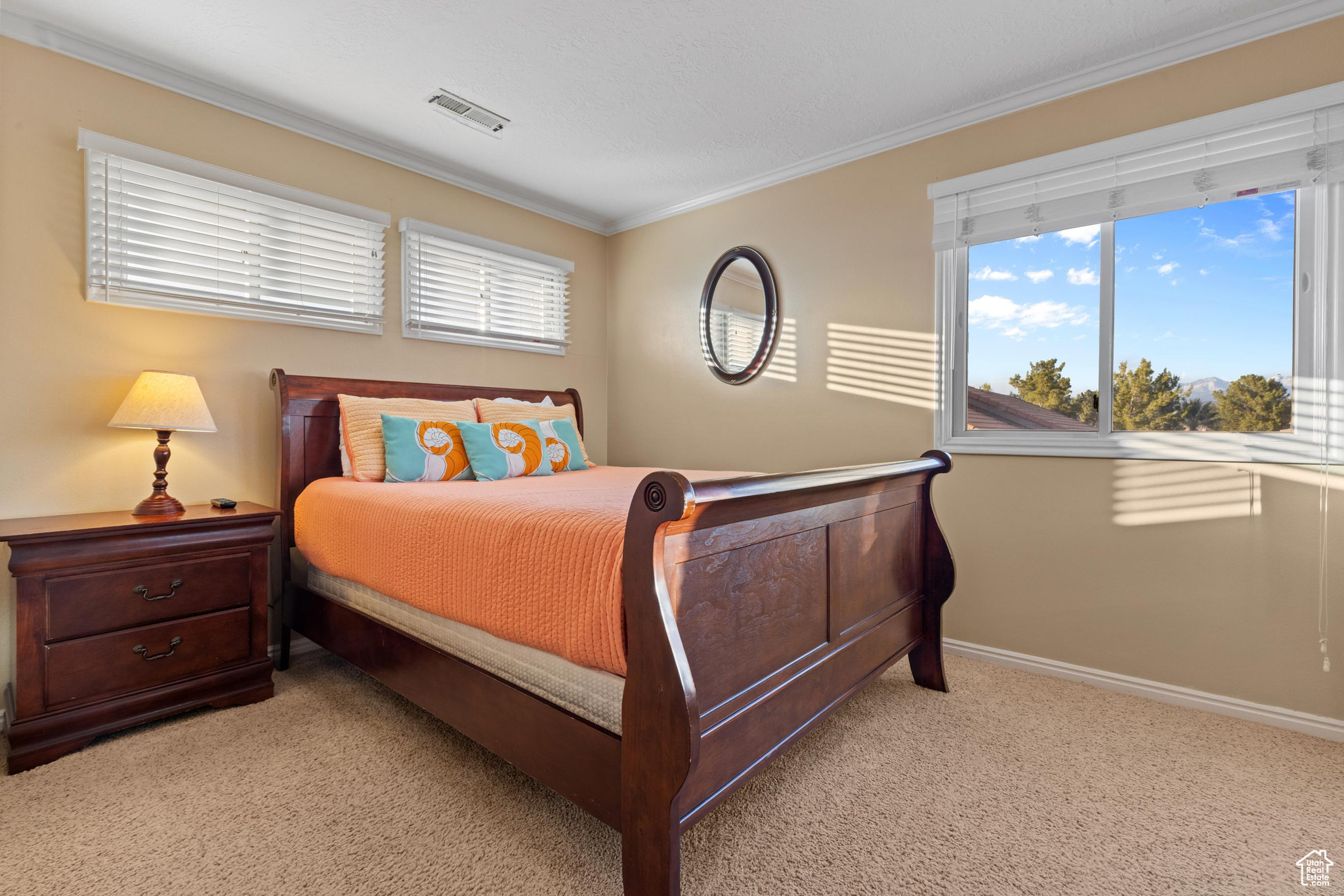 Bedroom featuring light colored carpet and ornamental molding