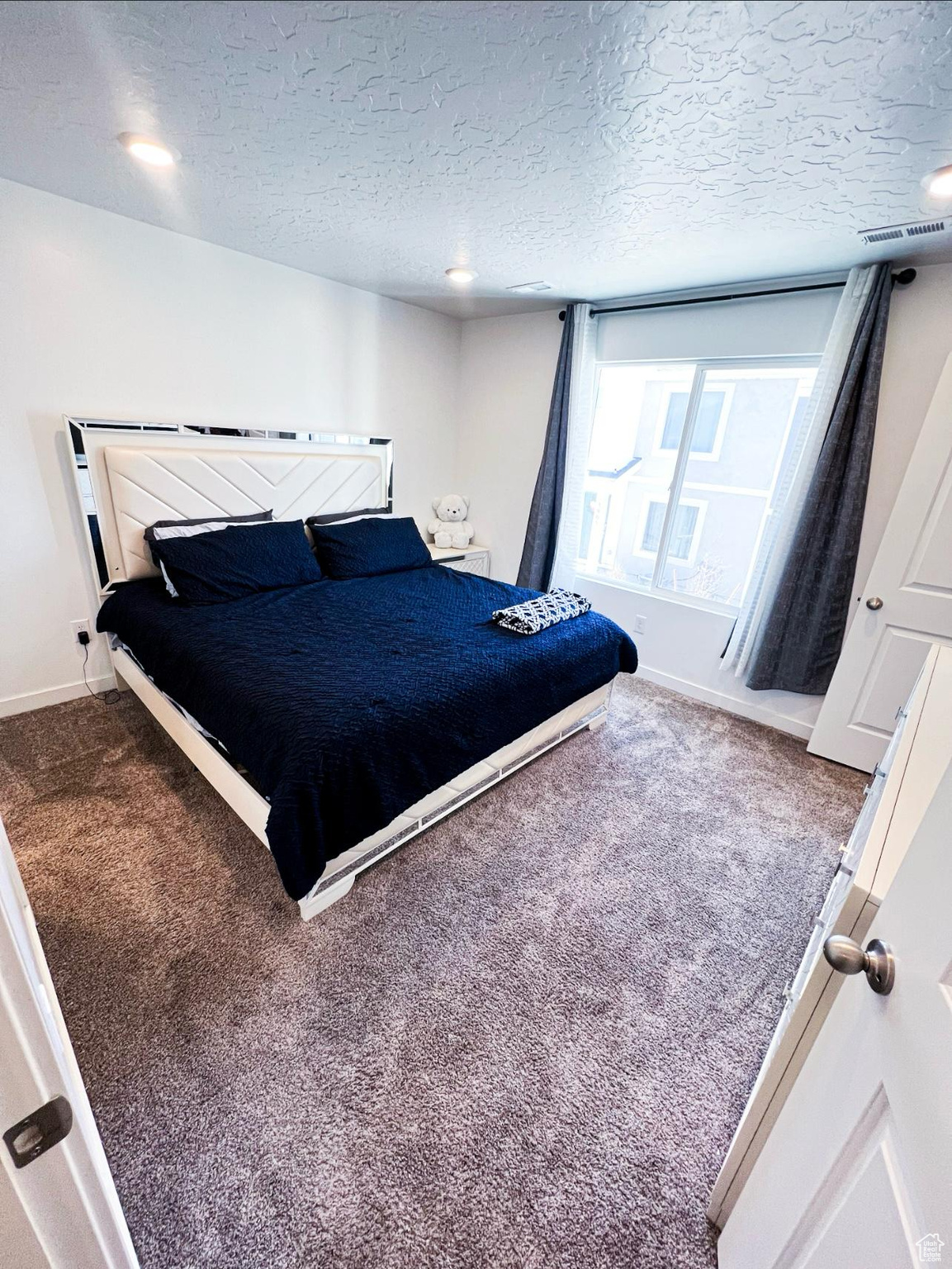 Master Bedroom featuring carpet and a textured ceiling