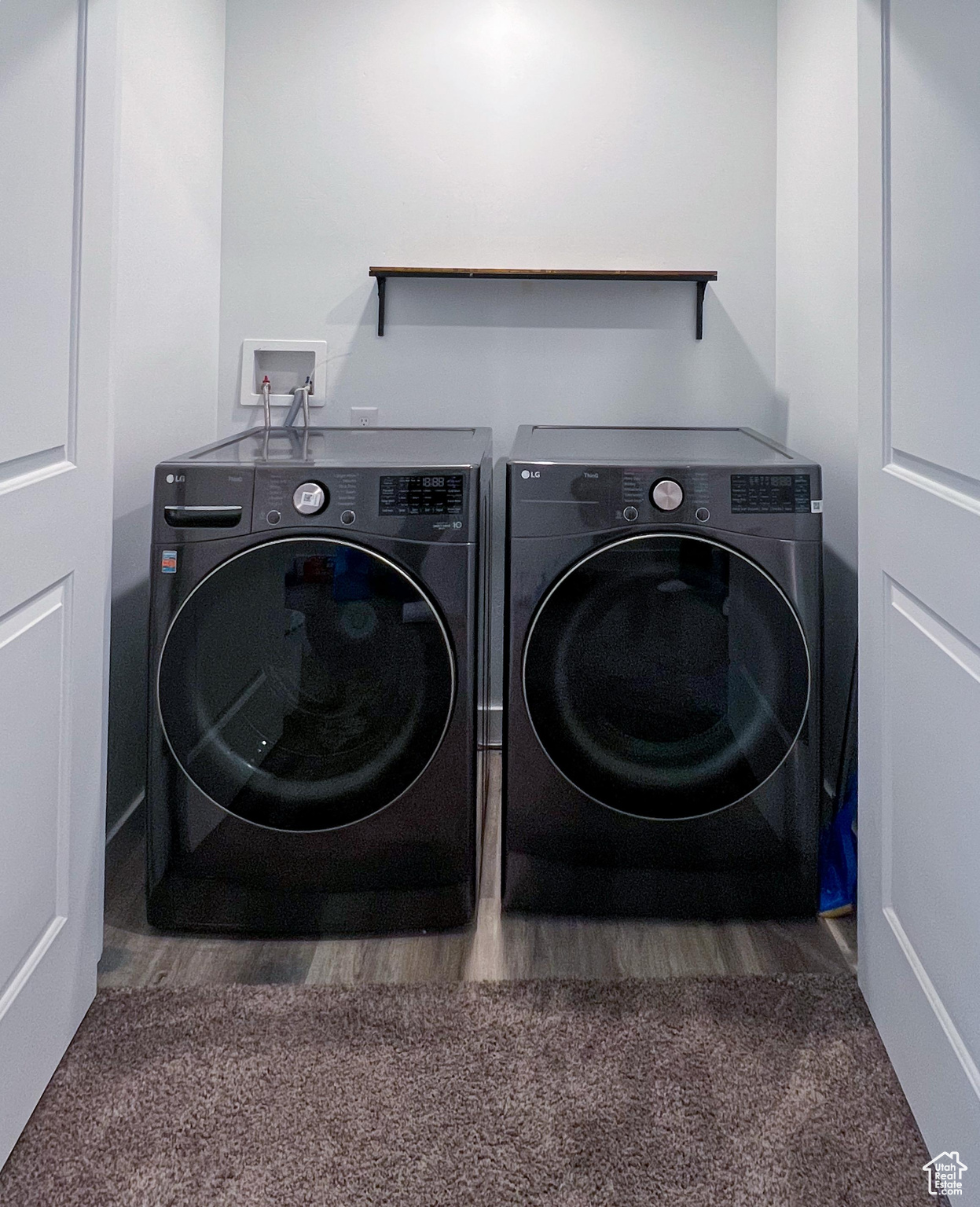 Laundry area with washing machine and clothes dryer and wood-type flooring