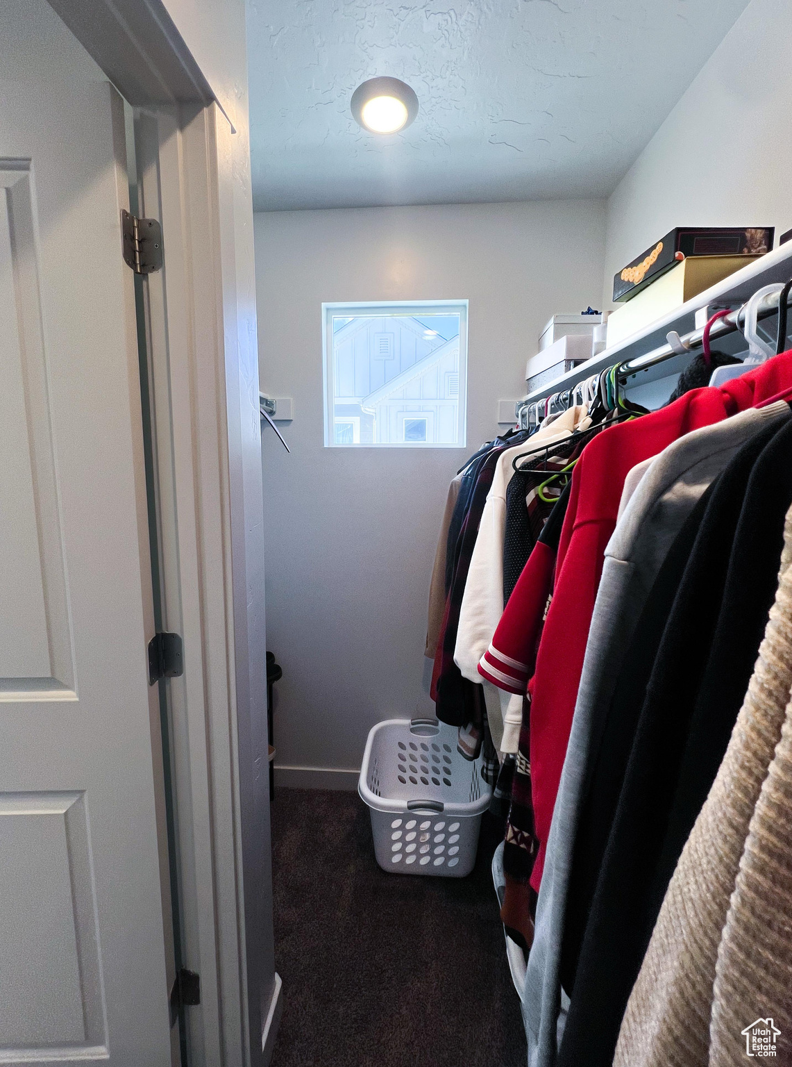 Walk in closet featuring dark colored carpet