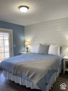 Bedroom with dark wood-type flooring