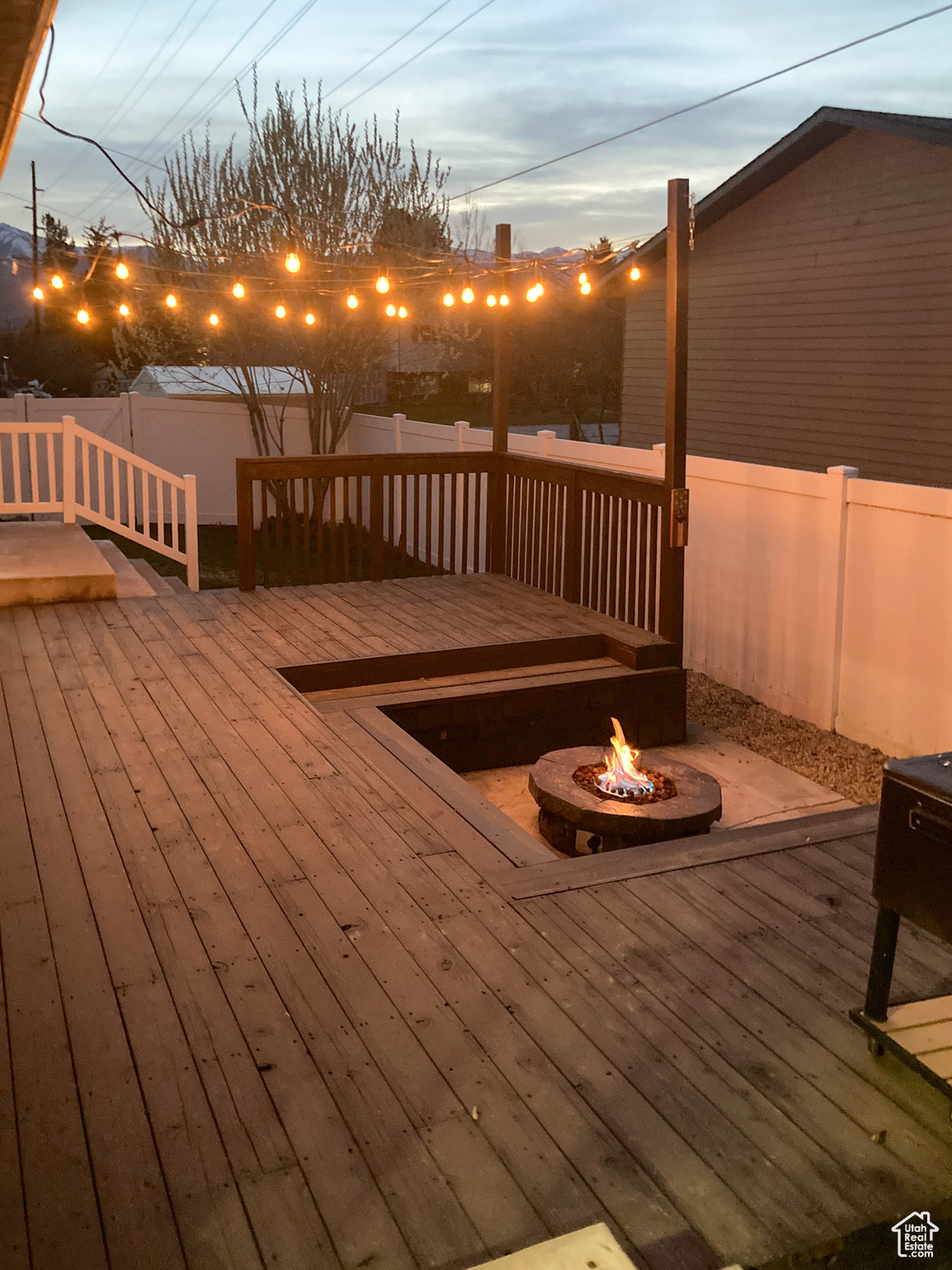 Deck at dusk featuring a fire pit
