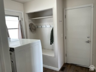 Laundry area featuring dark wood-type flooring and washing machine and dryer