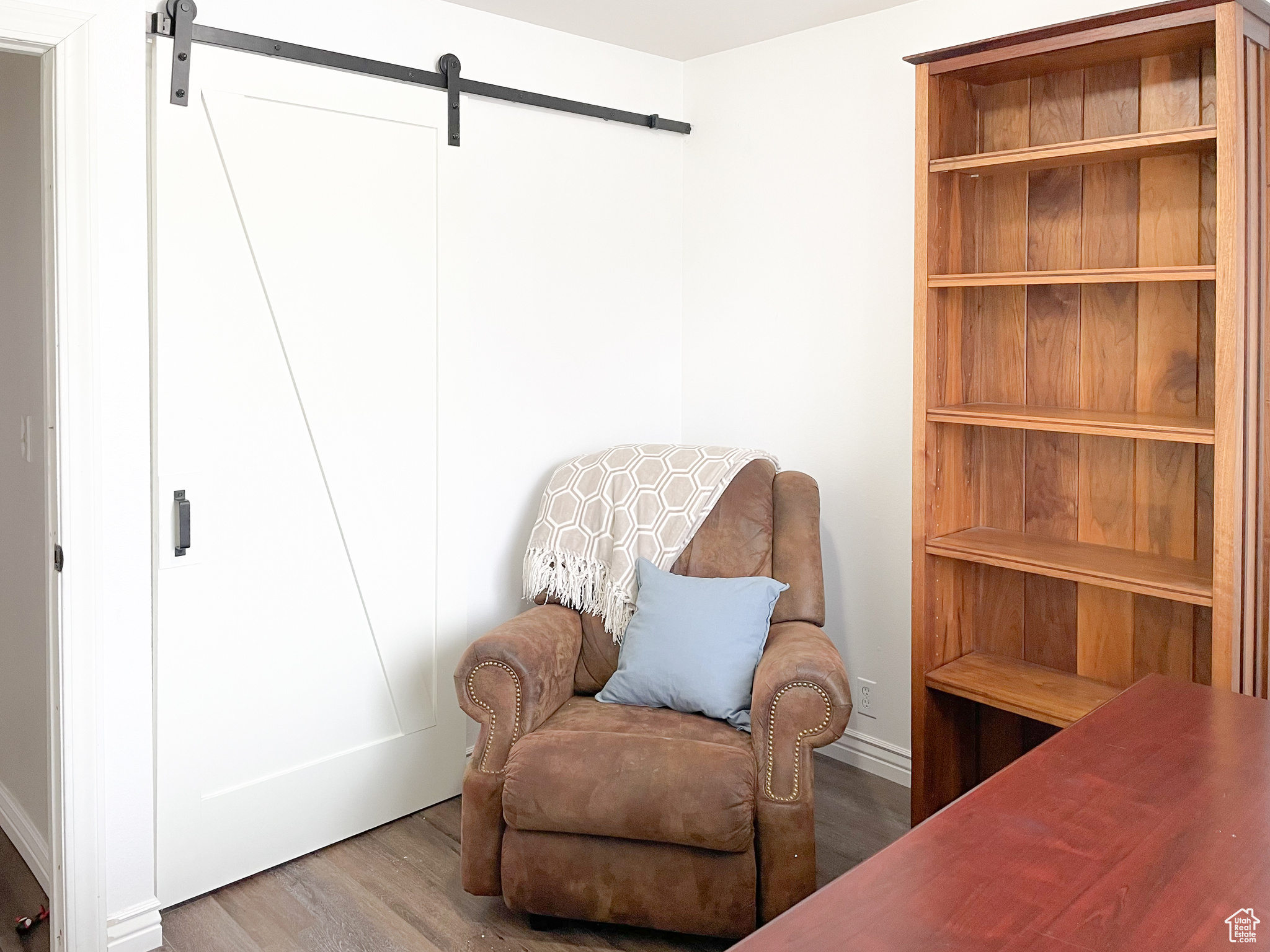 Living area featuring wood-type flooring and a barn door